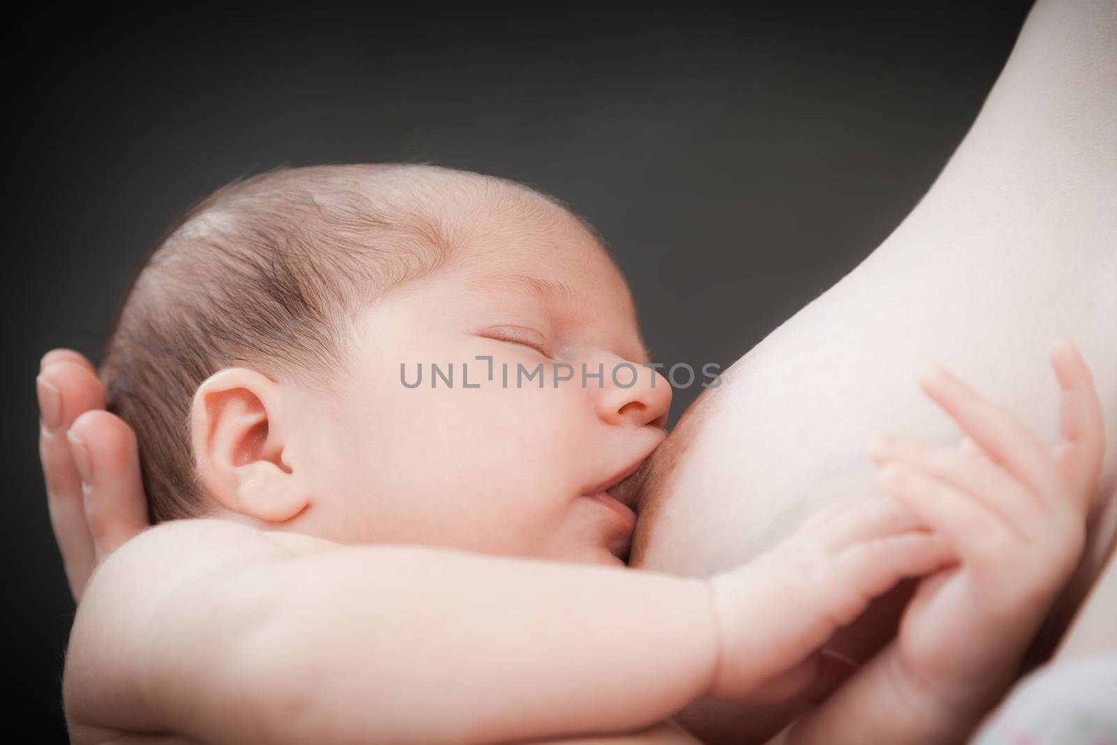 Baby feeds on mother's breasts milk by sveter