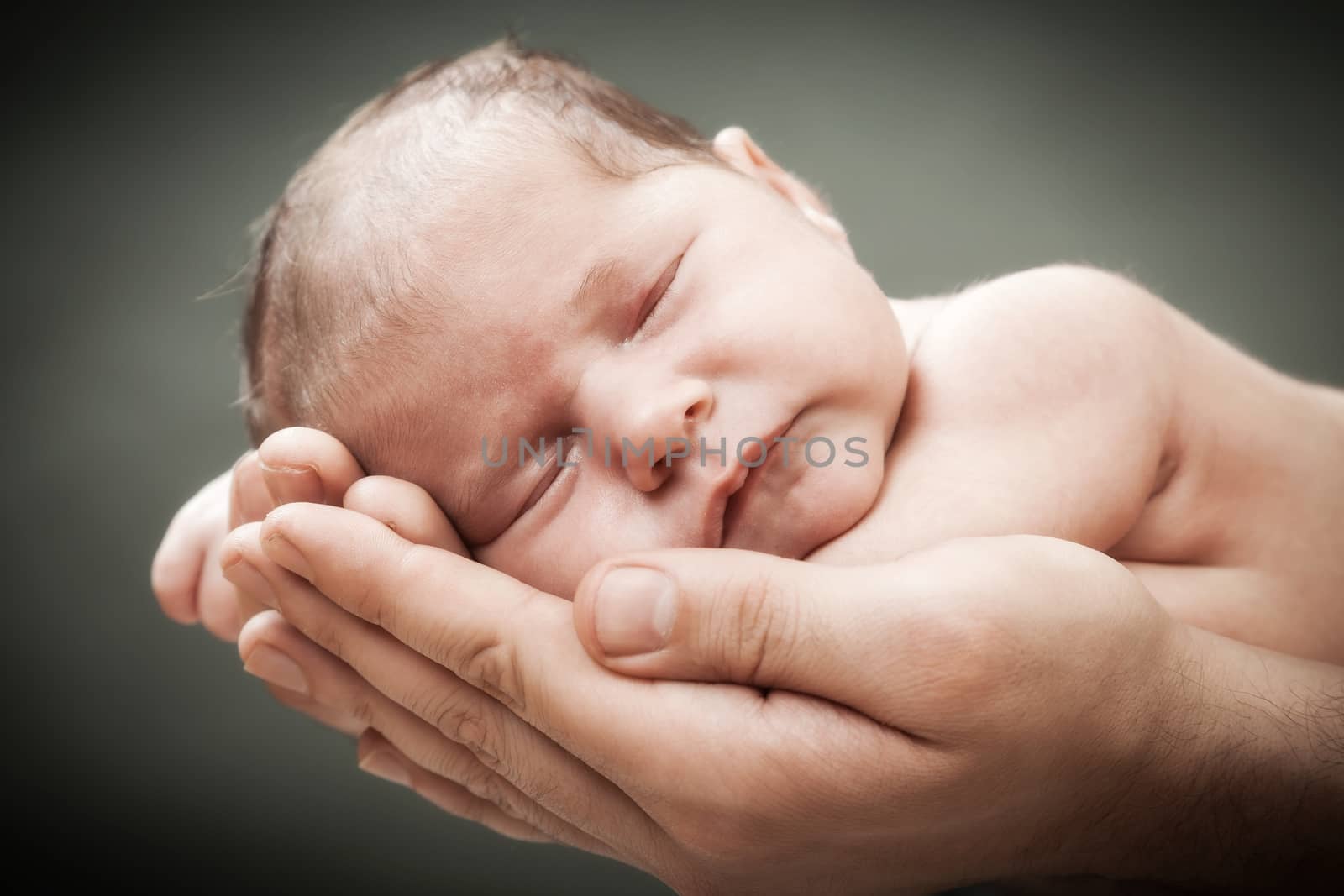 the newborn child on hands by sveter