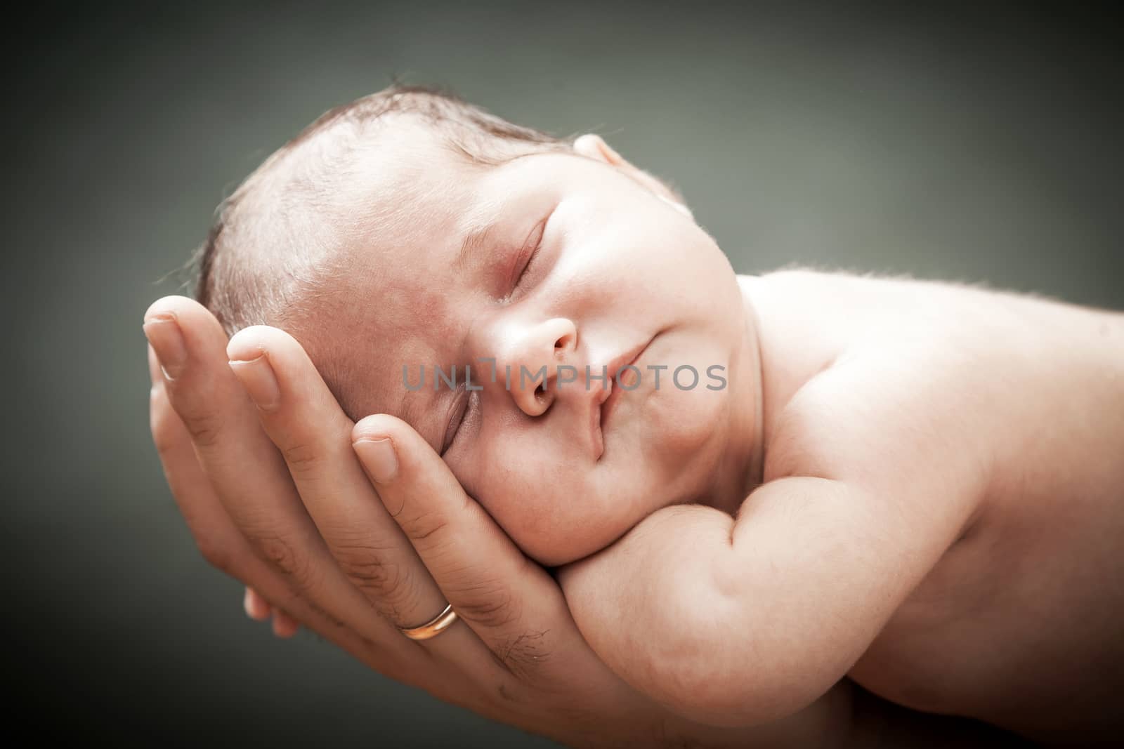 the newborn child on hands by sveter