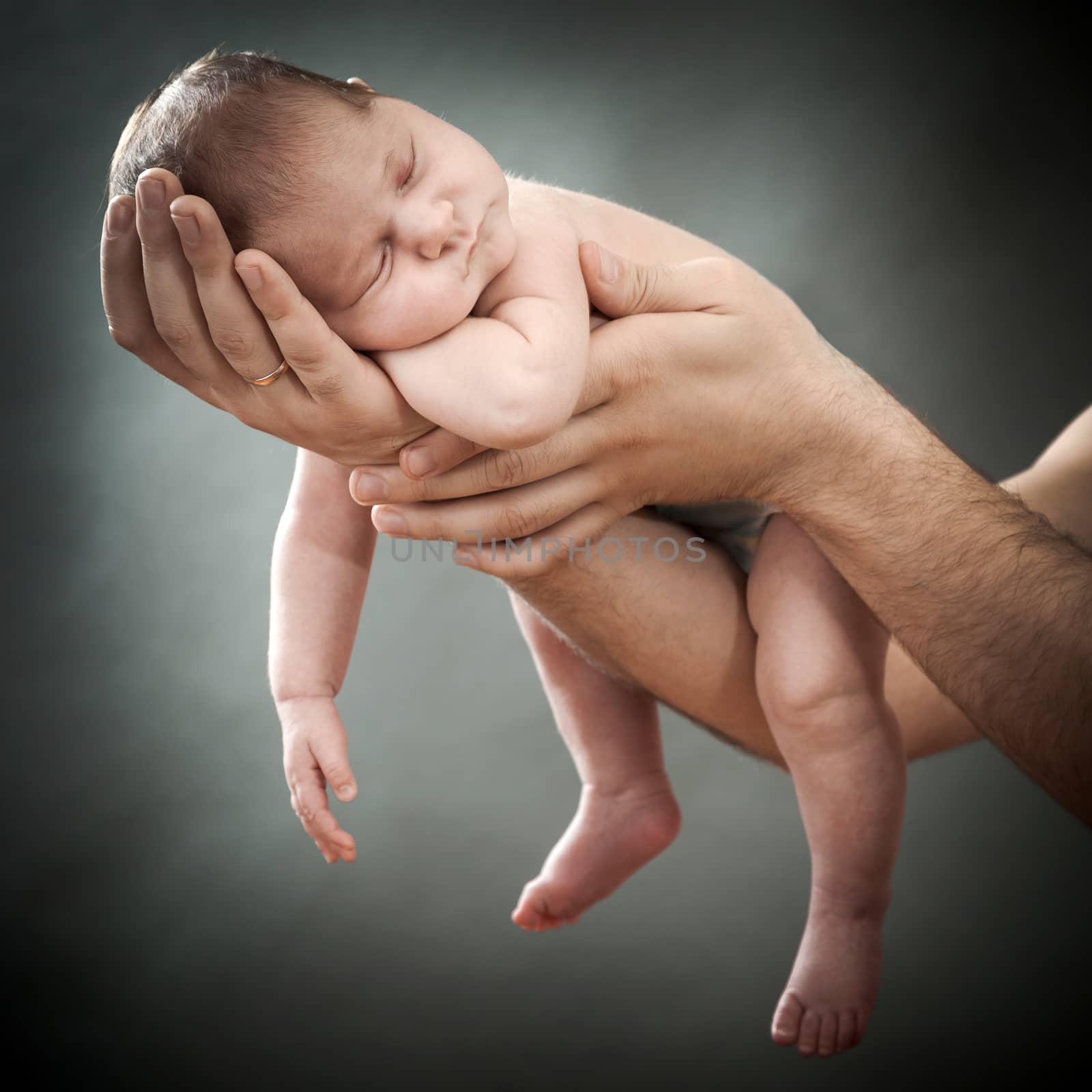 the newborn child on hands by sveter