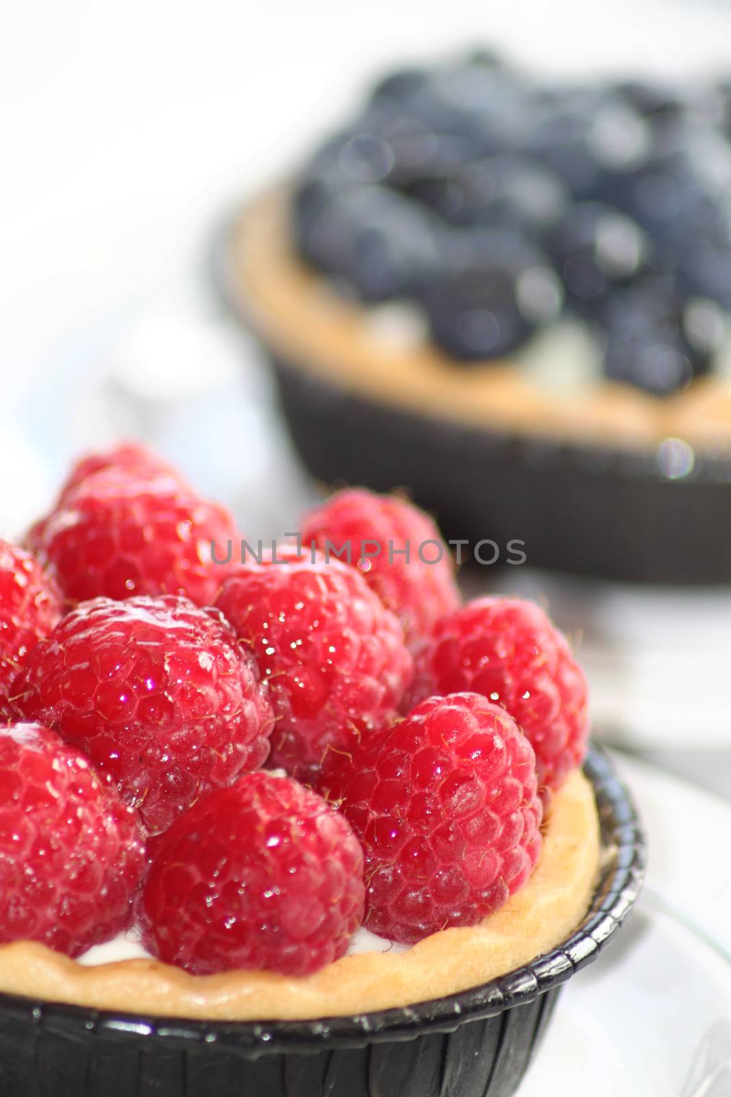 Cupcakes with raspberries and berries.
