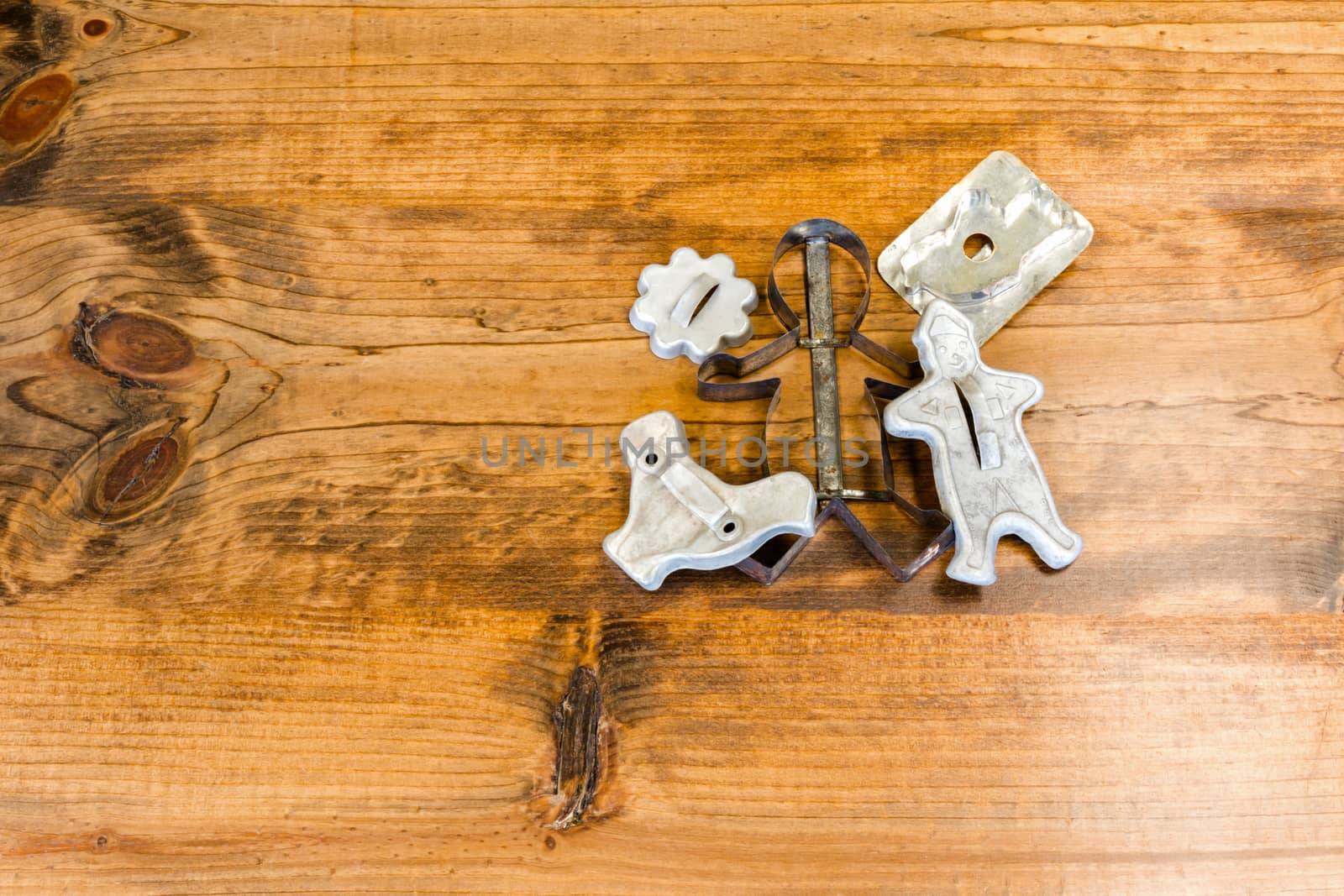 Tin Cookie Cutters Sitting on Wooden Table With Knots