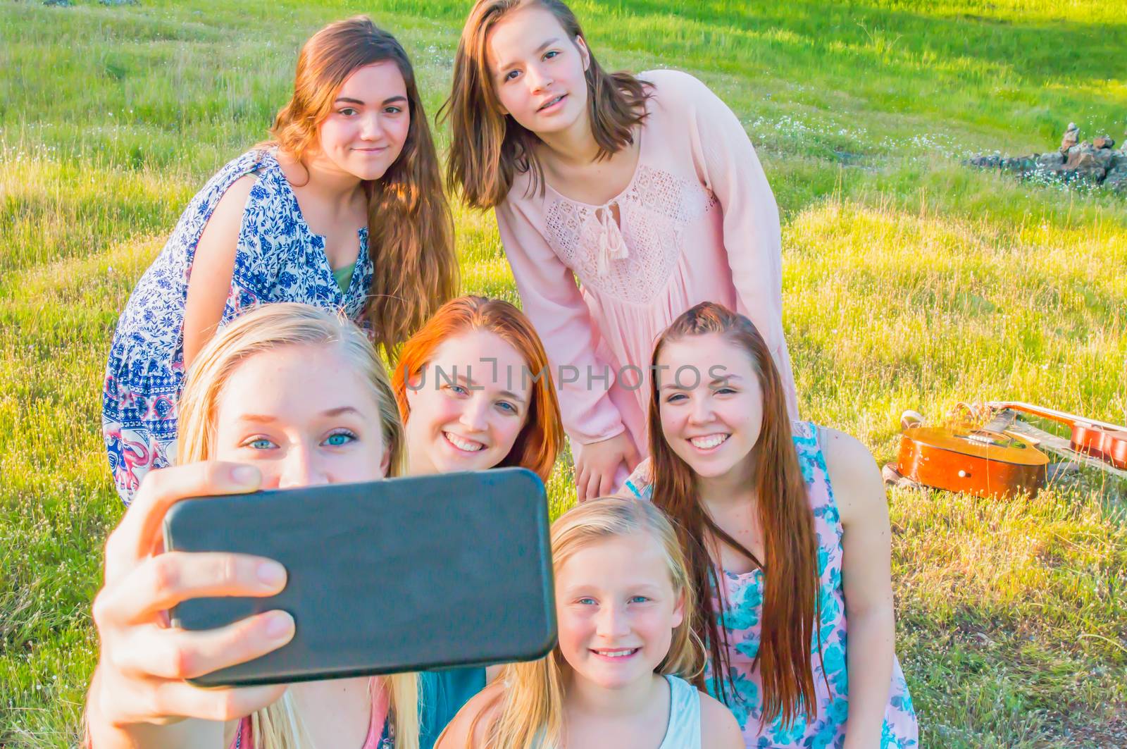 Group of Cute Young Girls  Taking a Selfie with Green Grass in the Background