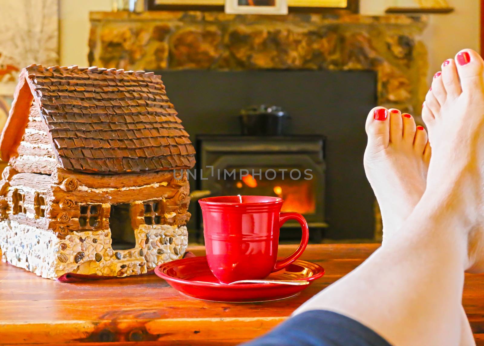 Feet Resting by the Fireplace With a Steaming Hot Cup of Tea