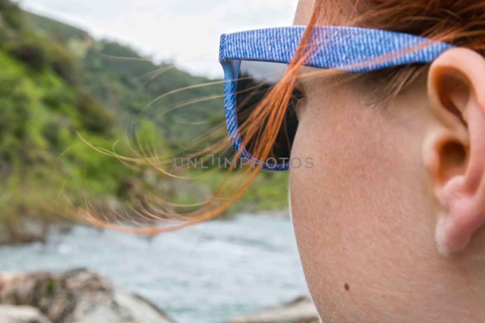 Young Girl With Sunglasses Looking Out Over River