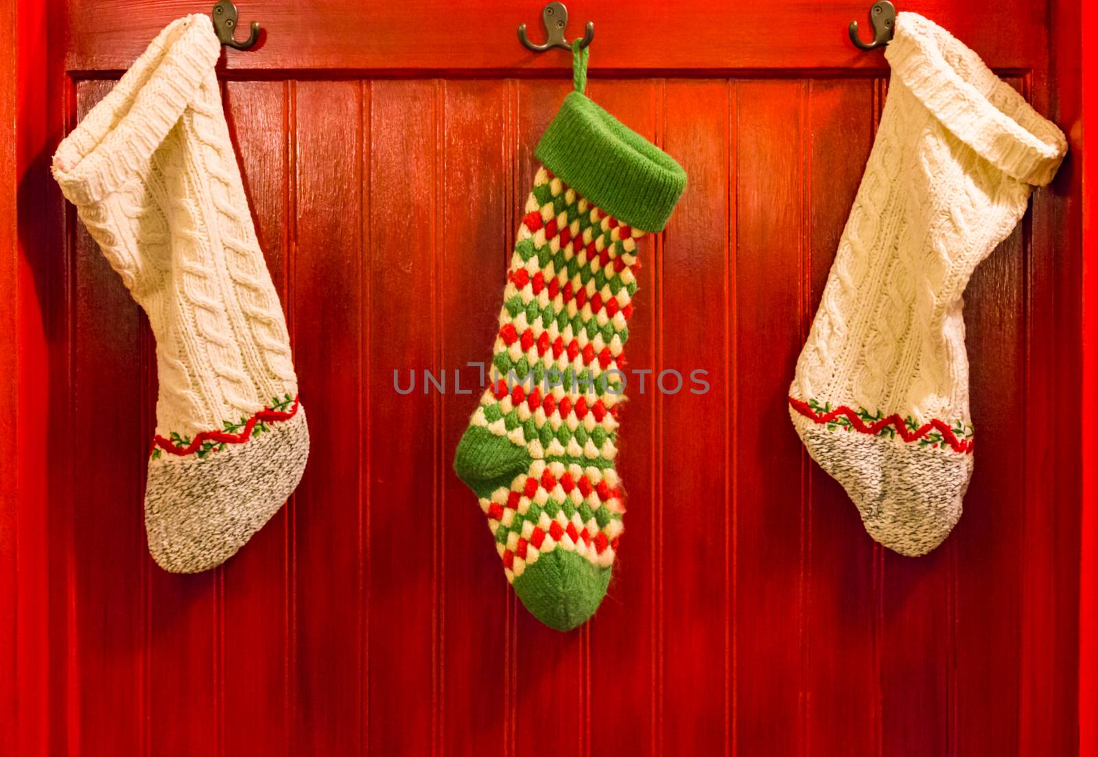 Three Christmas Stocking Hanging on Hooks