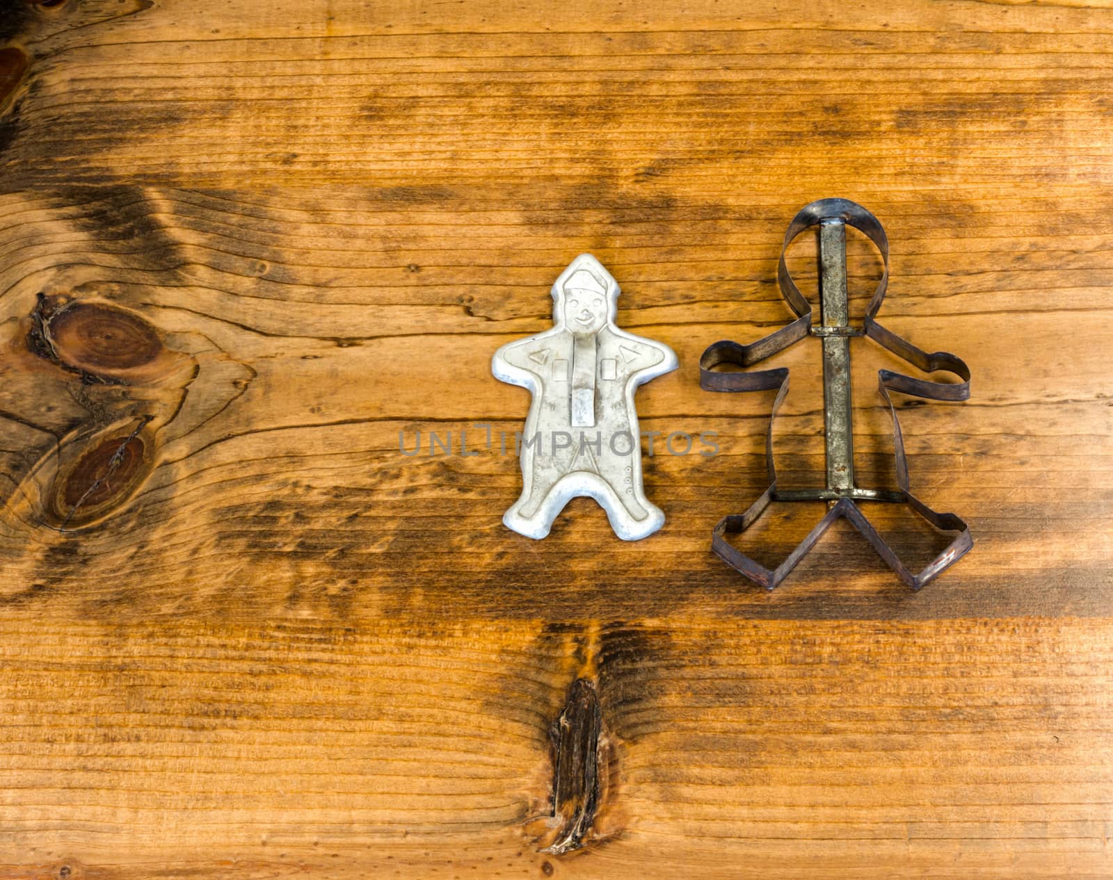 Tin Cookie Cutters Sitting on Wooden Table With Knots