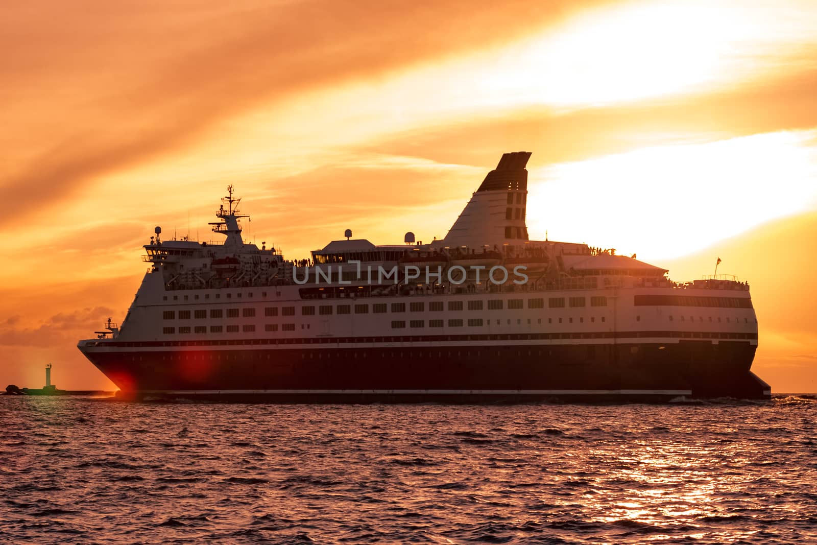 Cruise liner leaving Riga. Passenger ferry sailing at hot sunset