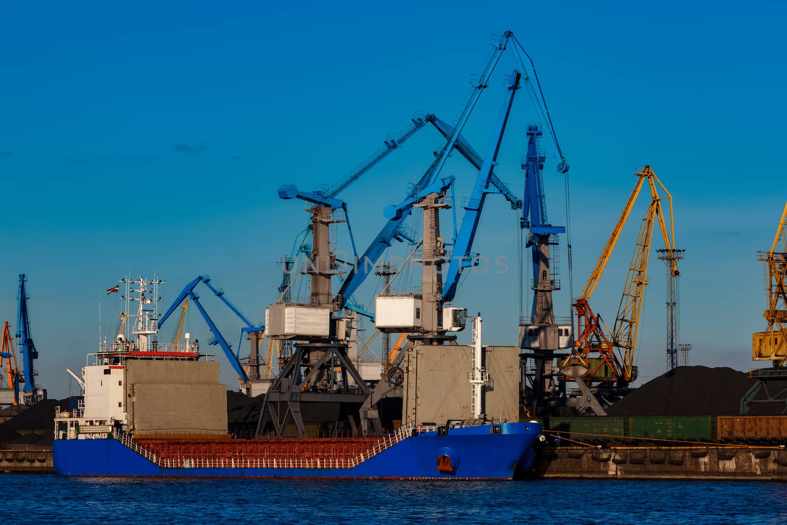 Blue cargo ship loading by sengnsp