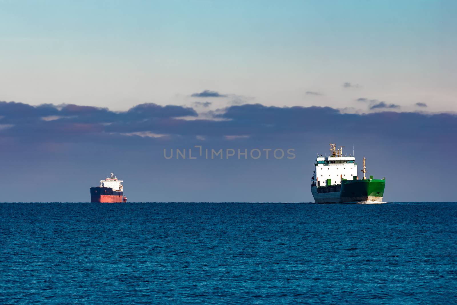 Cargo ships far in still water of Baltic sea