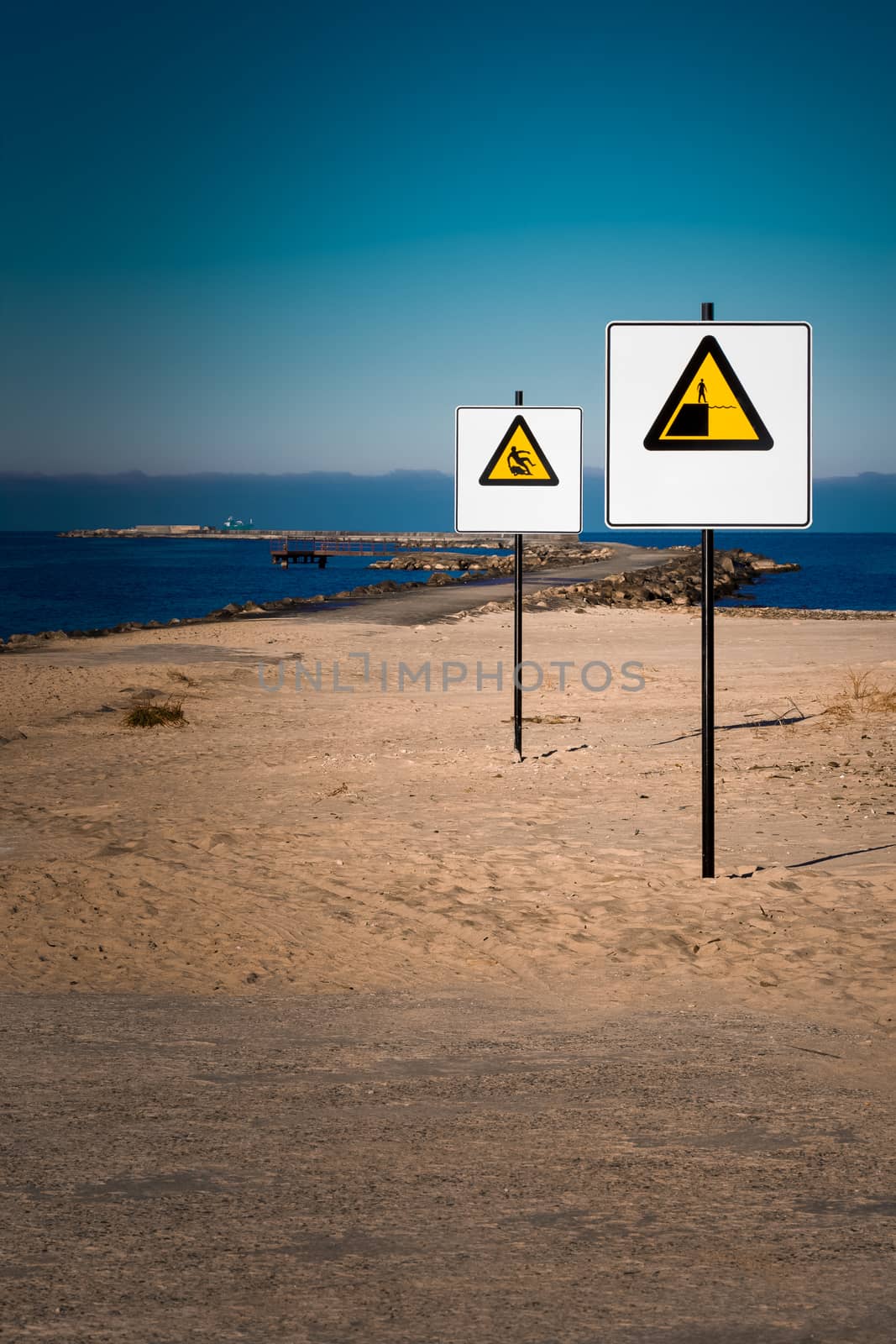 Yellow warning signs on summer beach, Riga