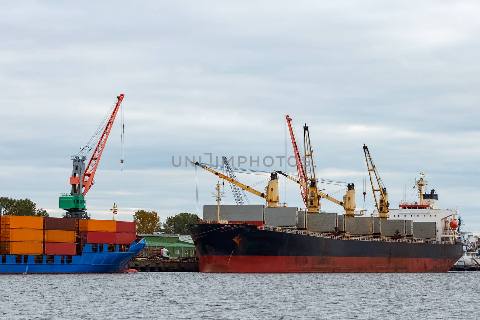 Black cargo ship loading in the port of Riga, Europe