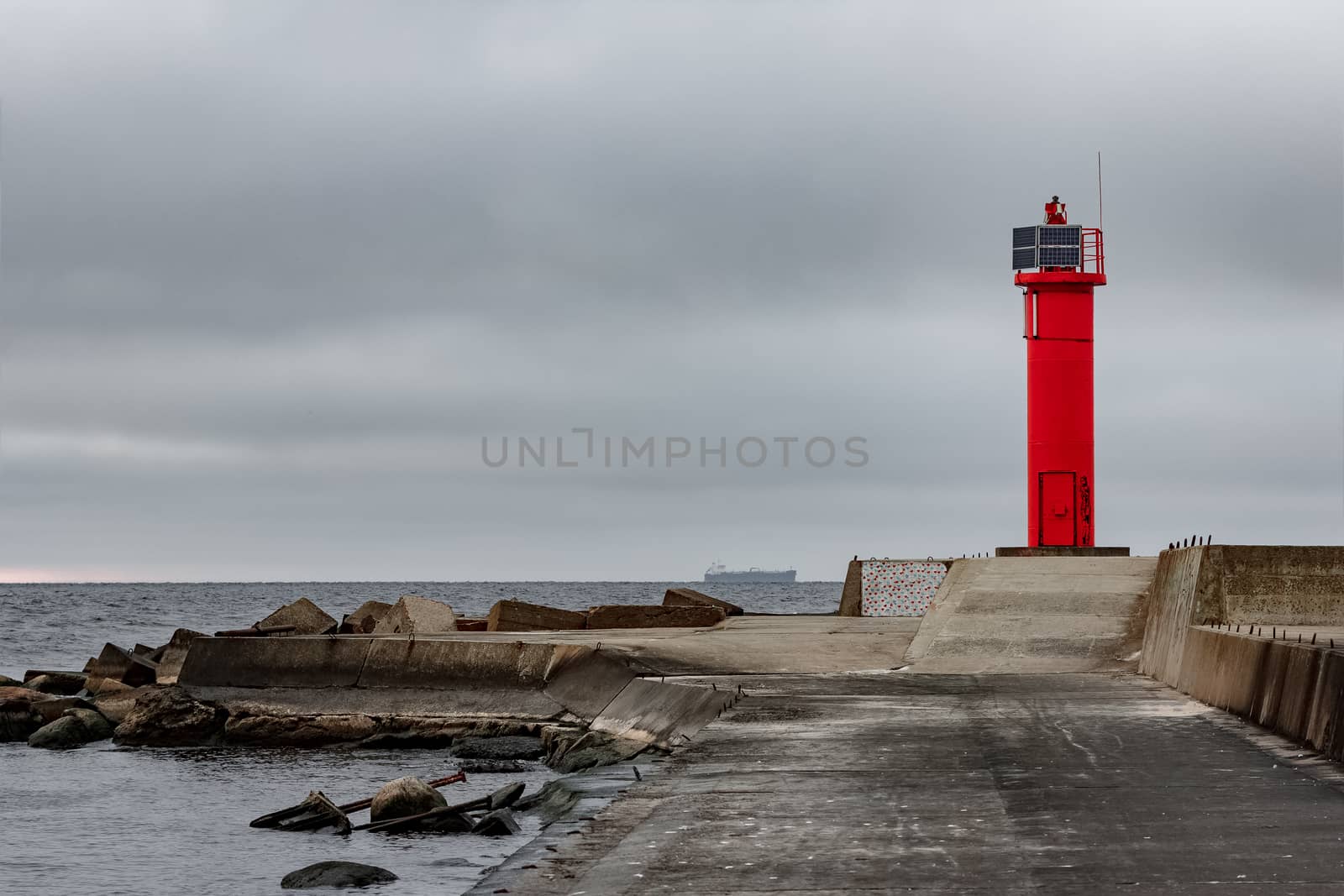 Breakwater dam with red lighthouse by sengnsp