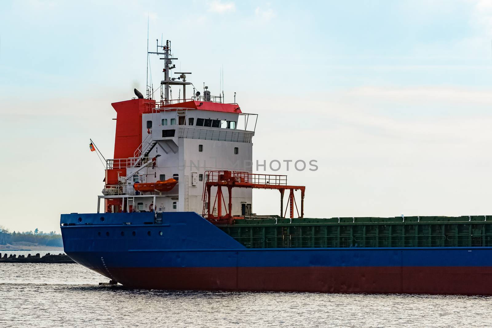 Blue cargo ship's cabin leaving the port of Riga