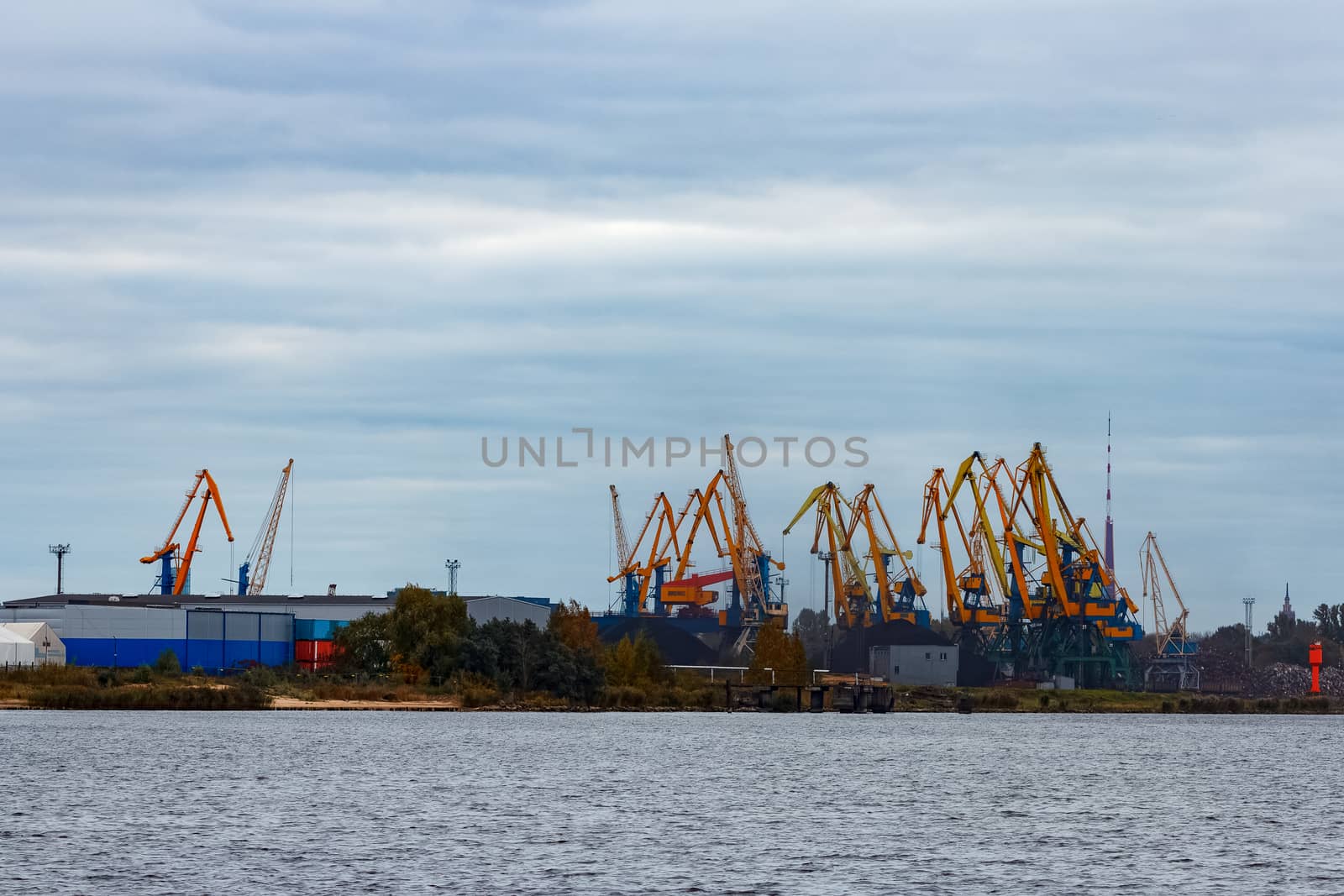 Yellow cargo cranes in the port of Riga, Europe