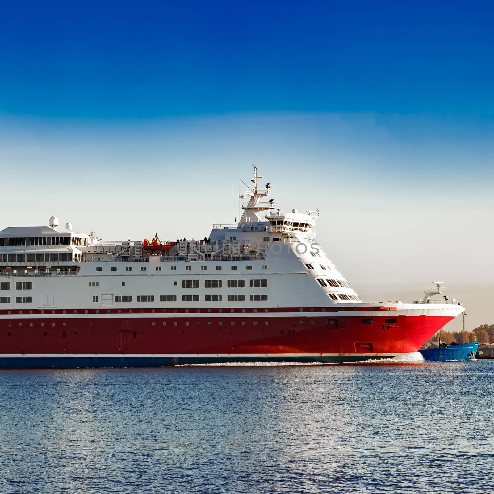 Red cruise liner. Passenger ferry ship sailing in still water