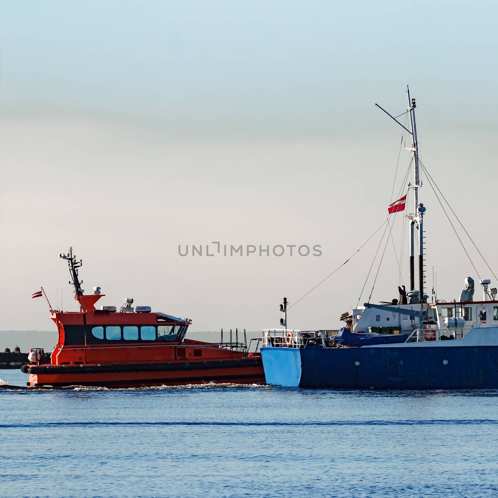 Blue cargo ship leaving Riga and entering Baltic sea