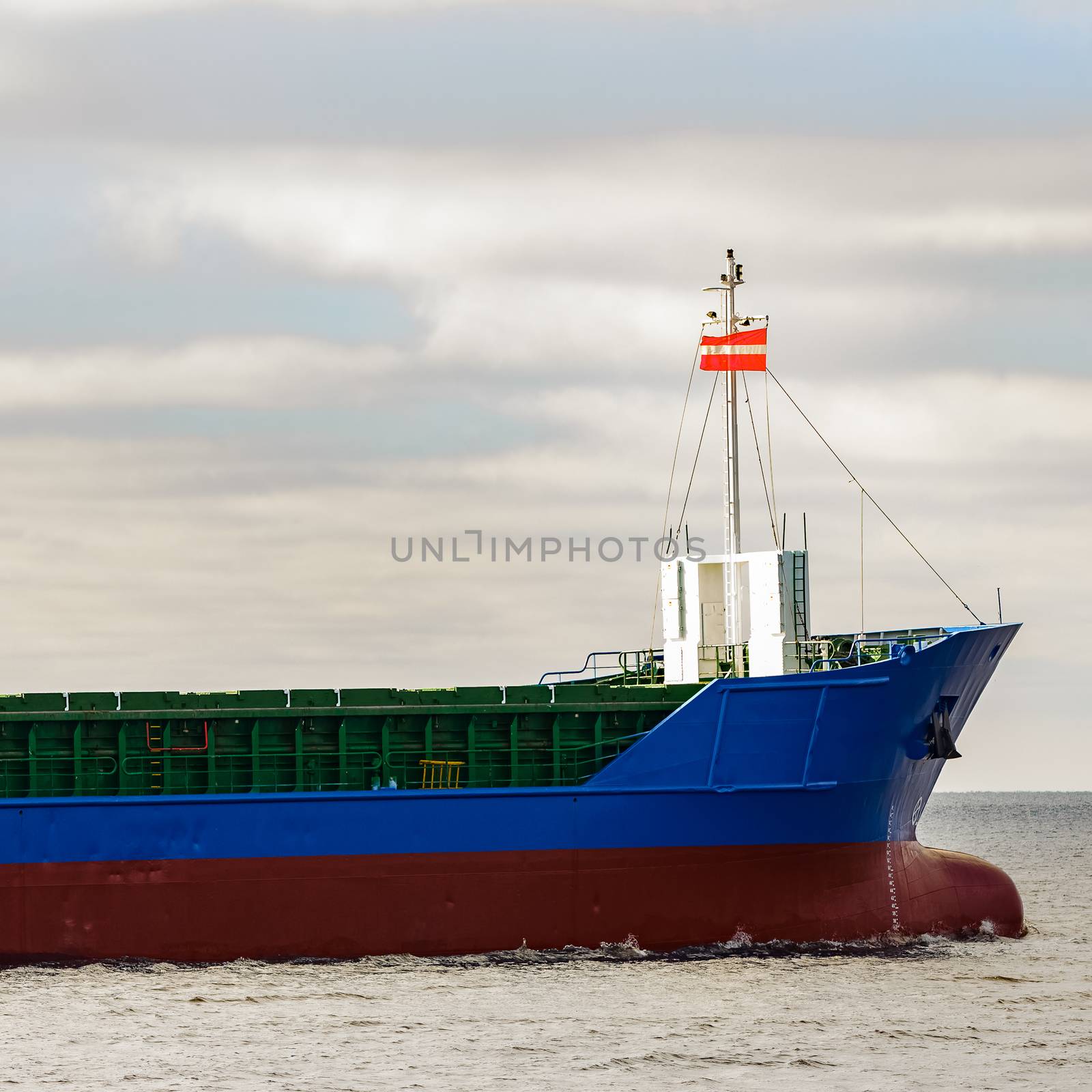 Blue cargo ship's bow leaving the port of Riga