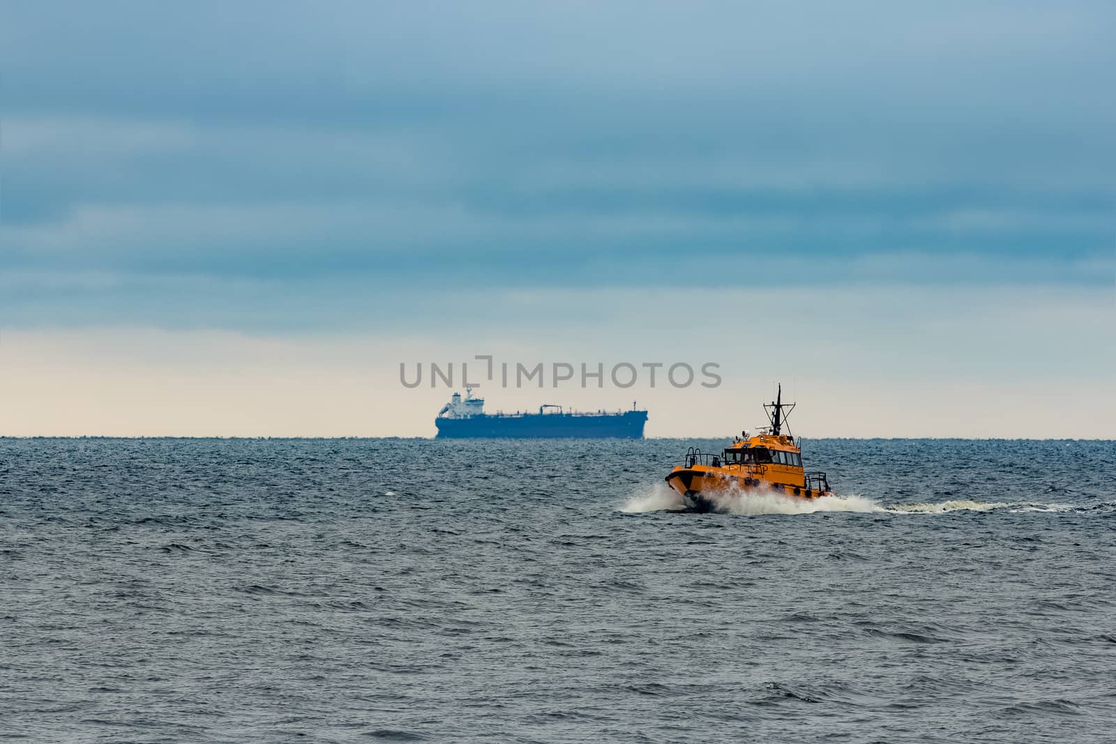 Orange pilot ship moving at speed in Baltic sea