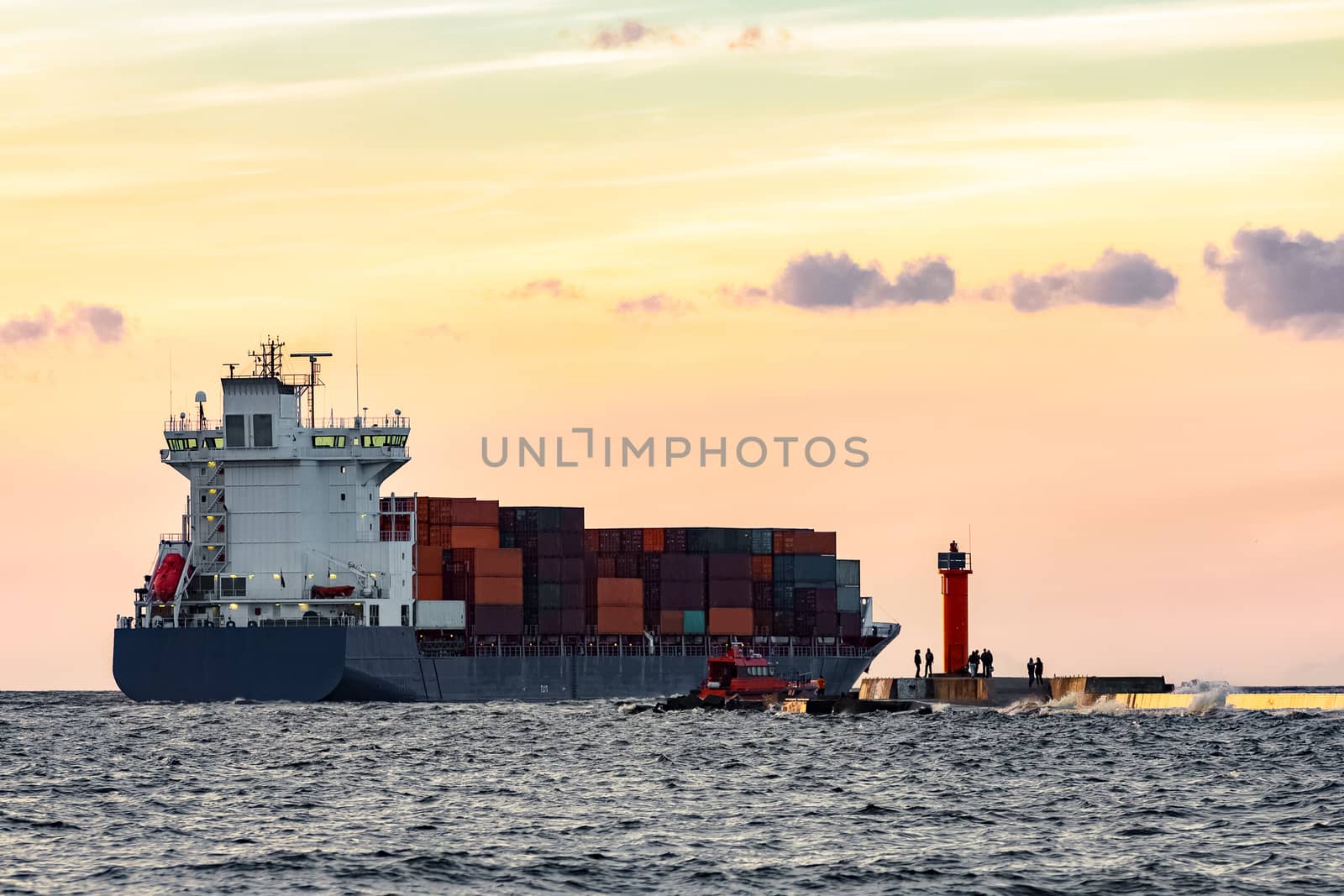 Blue container ship leaving Riga and entering Baltic sea