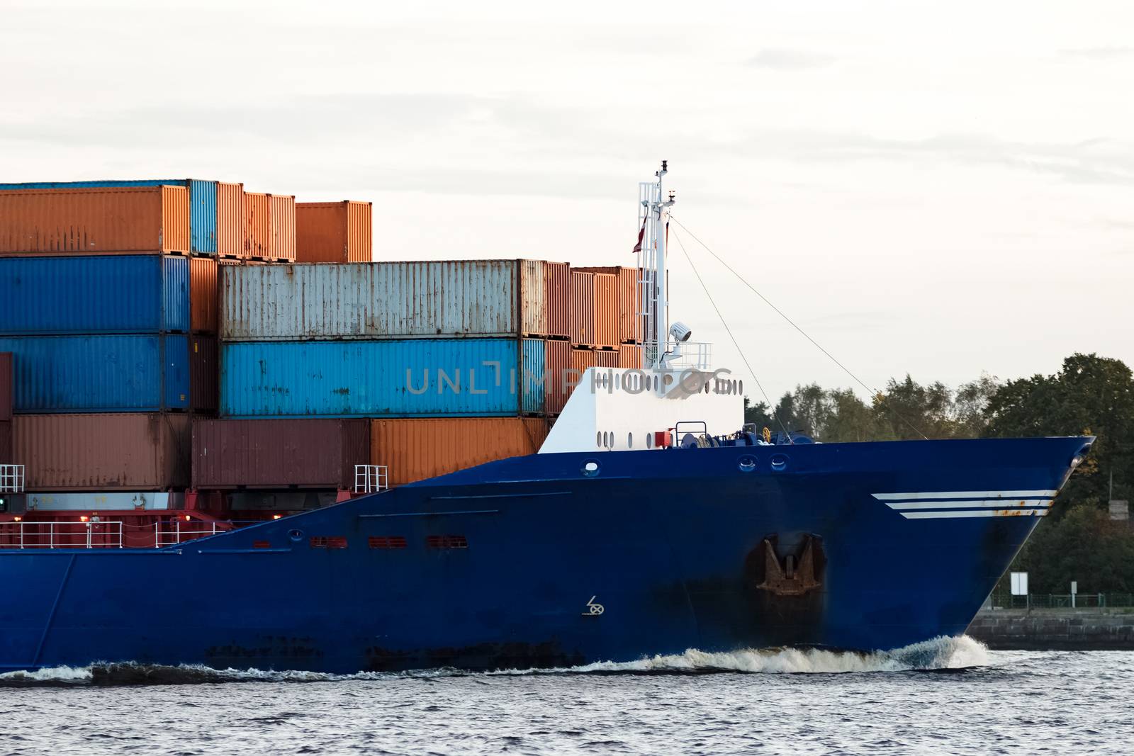 Blue container ship's bow at Daugava river, Latvia