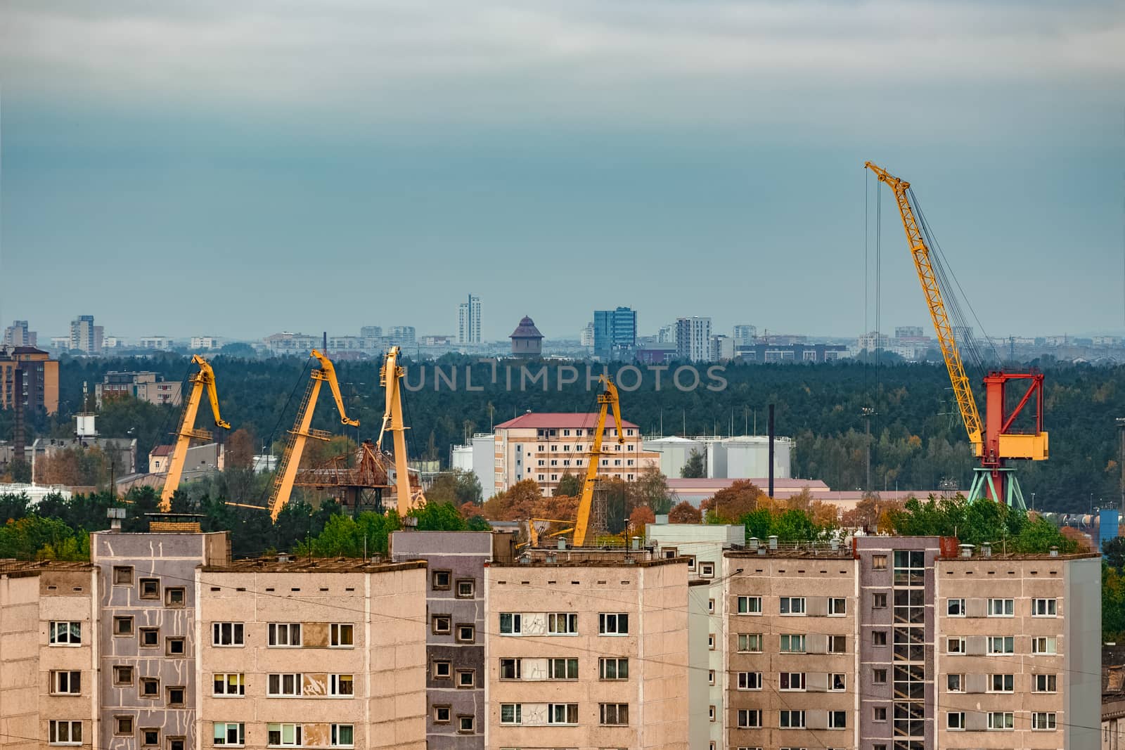 Residential area in Riga with soviet houses and cargo cranes