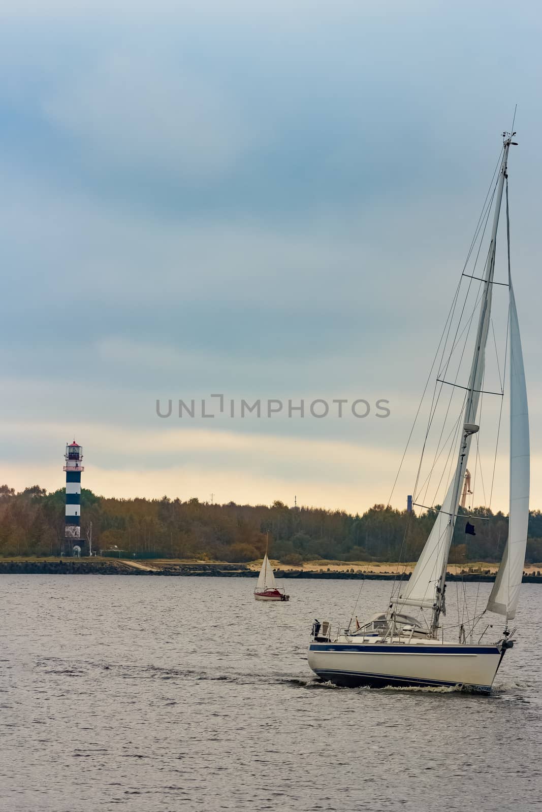 White sailboat traveling by sengnsp