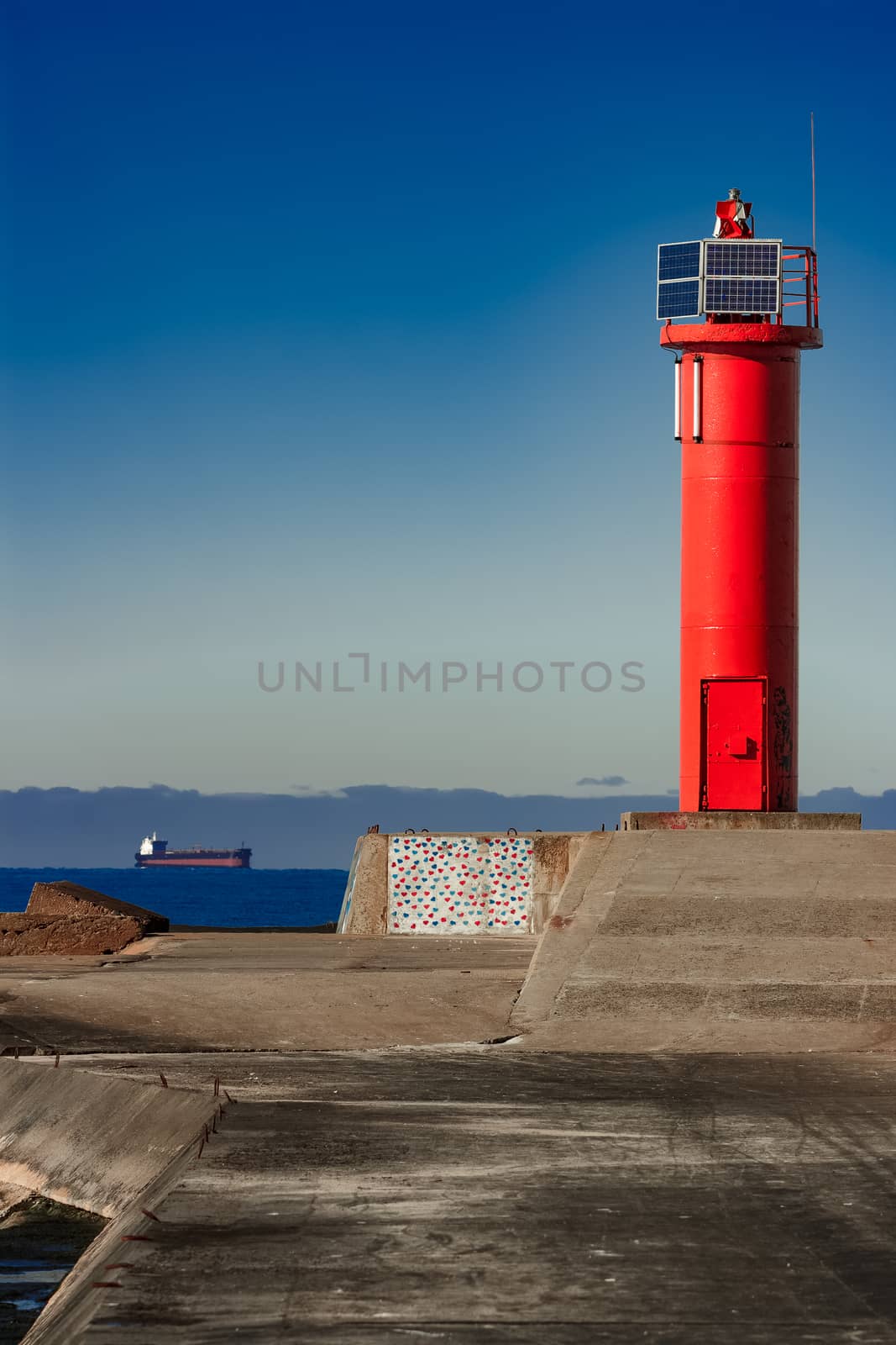 Red lighthouse on breakwater dam in Riga, Europe