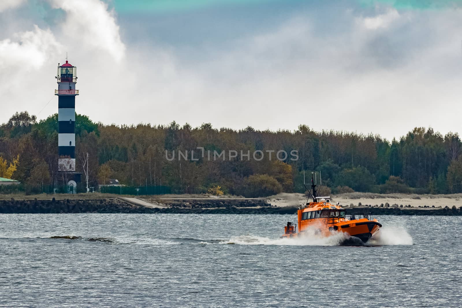 Orange pilot ship moving at speed by sengnsp