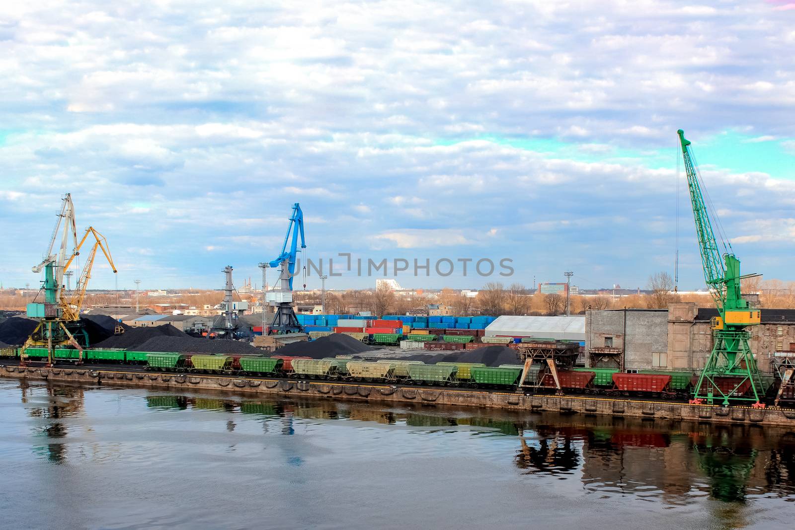 Baltic coal terminal with port cranes near the river. Riga cargo