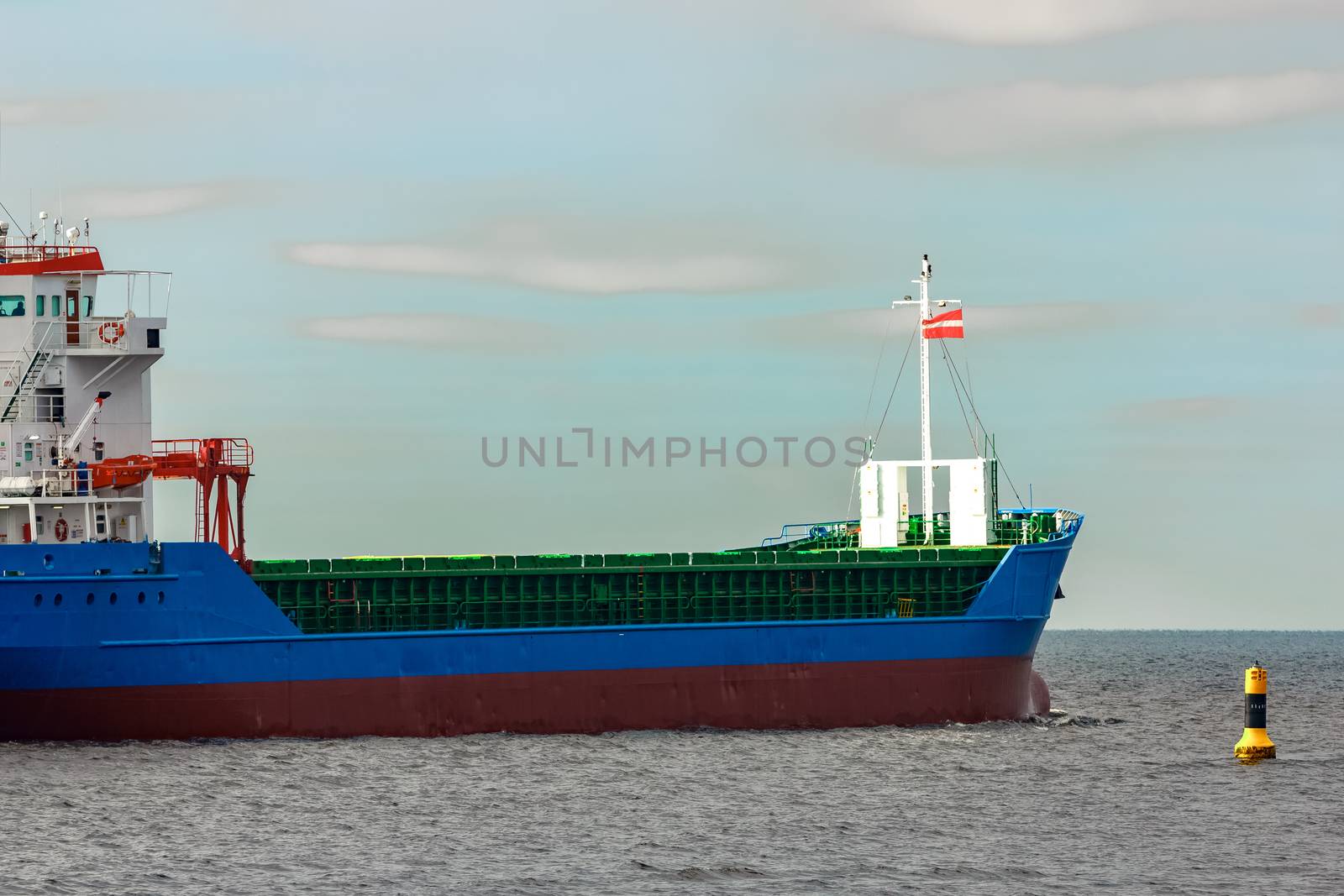 Blue cargo ship entering the Baltic sea. Riga, Europe