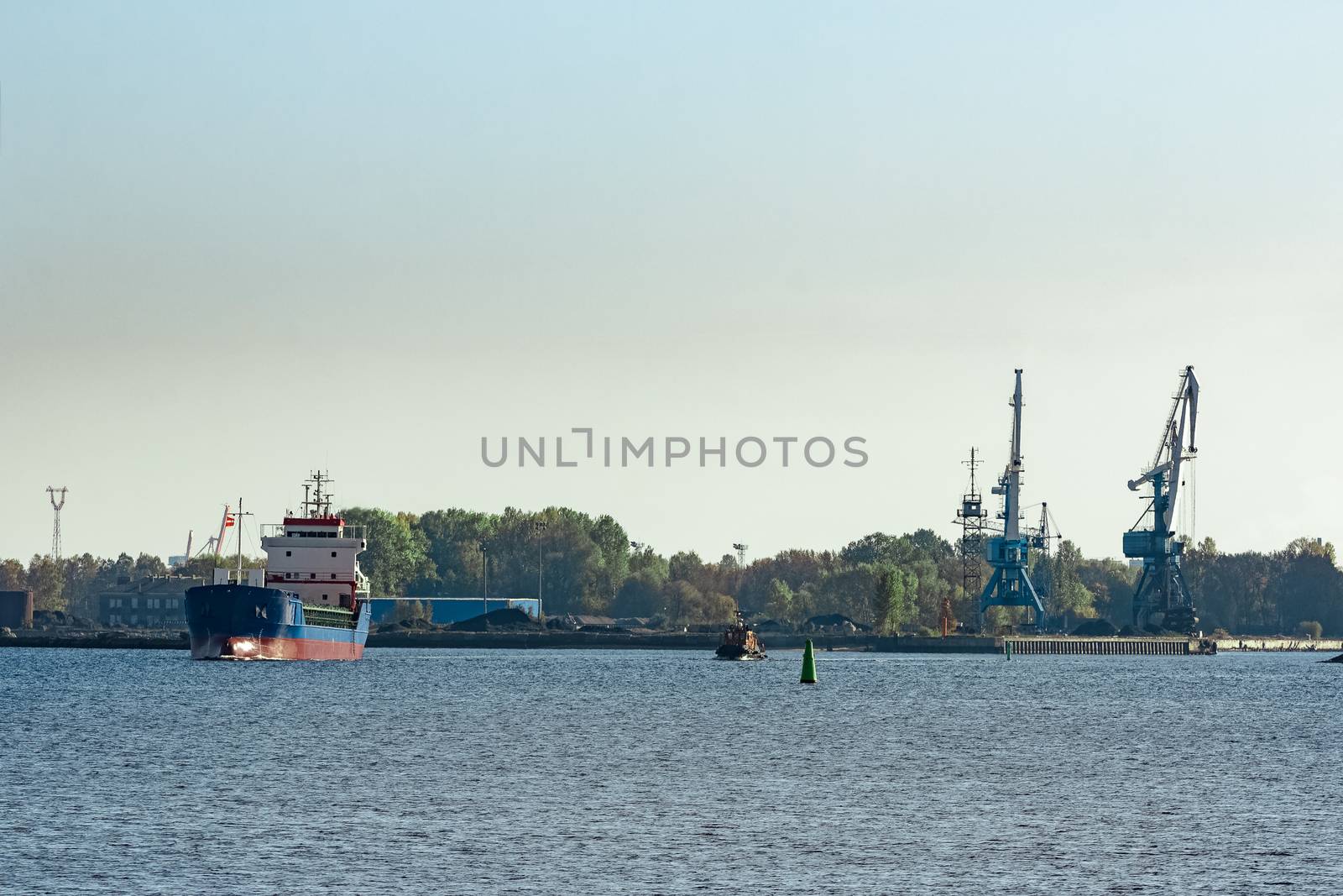 Blue cargo ship leaving the port of Riga