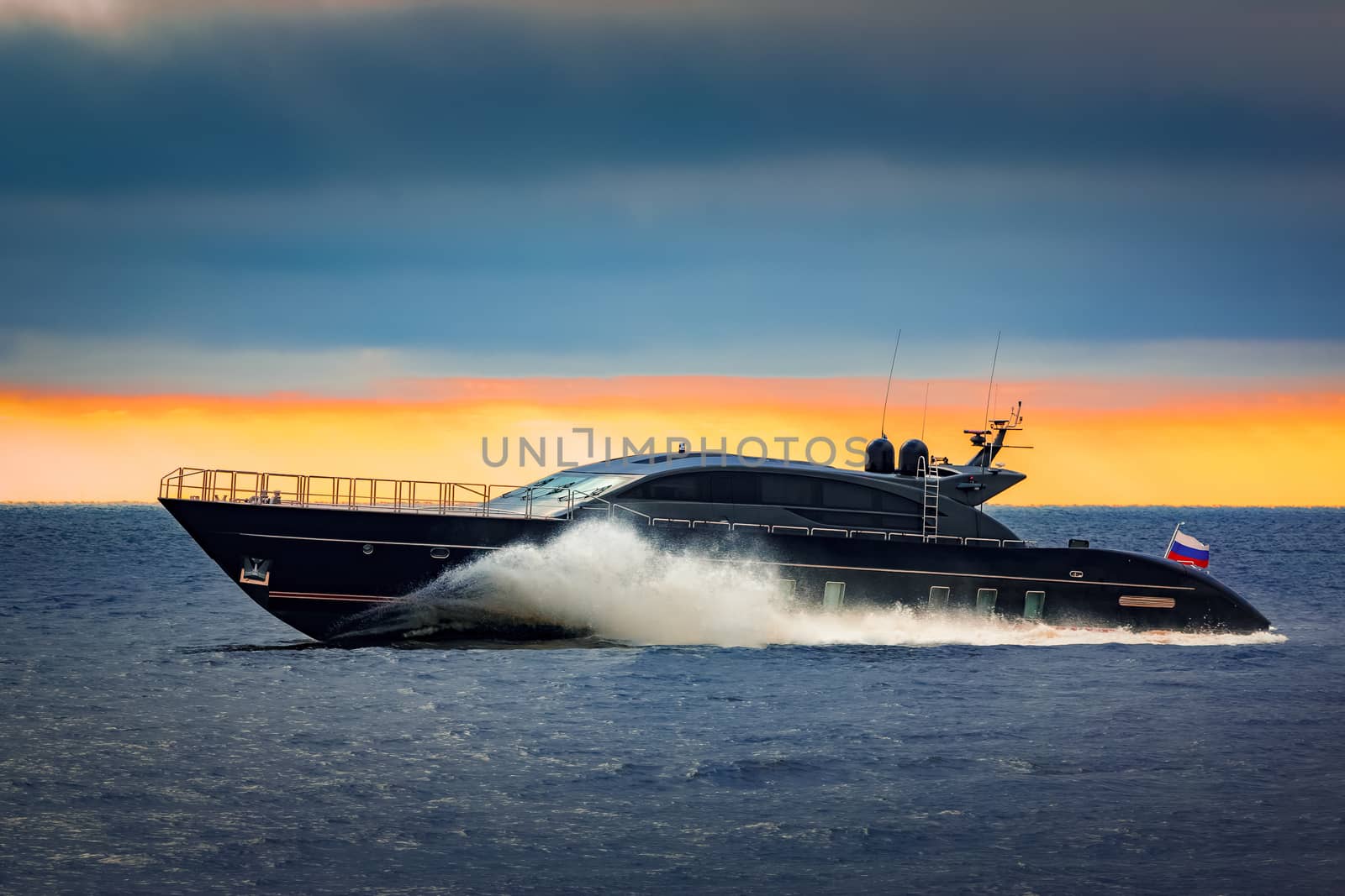 Black elite speed motor boat moving fast from Baltic sea