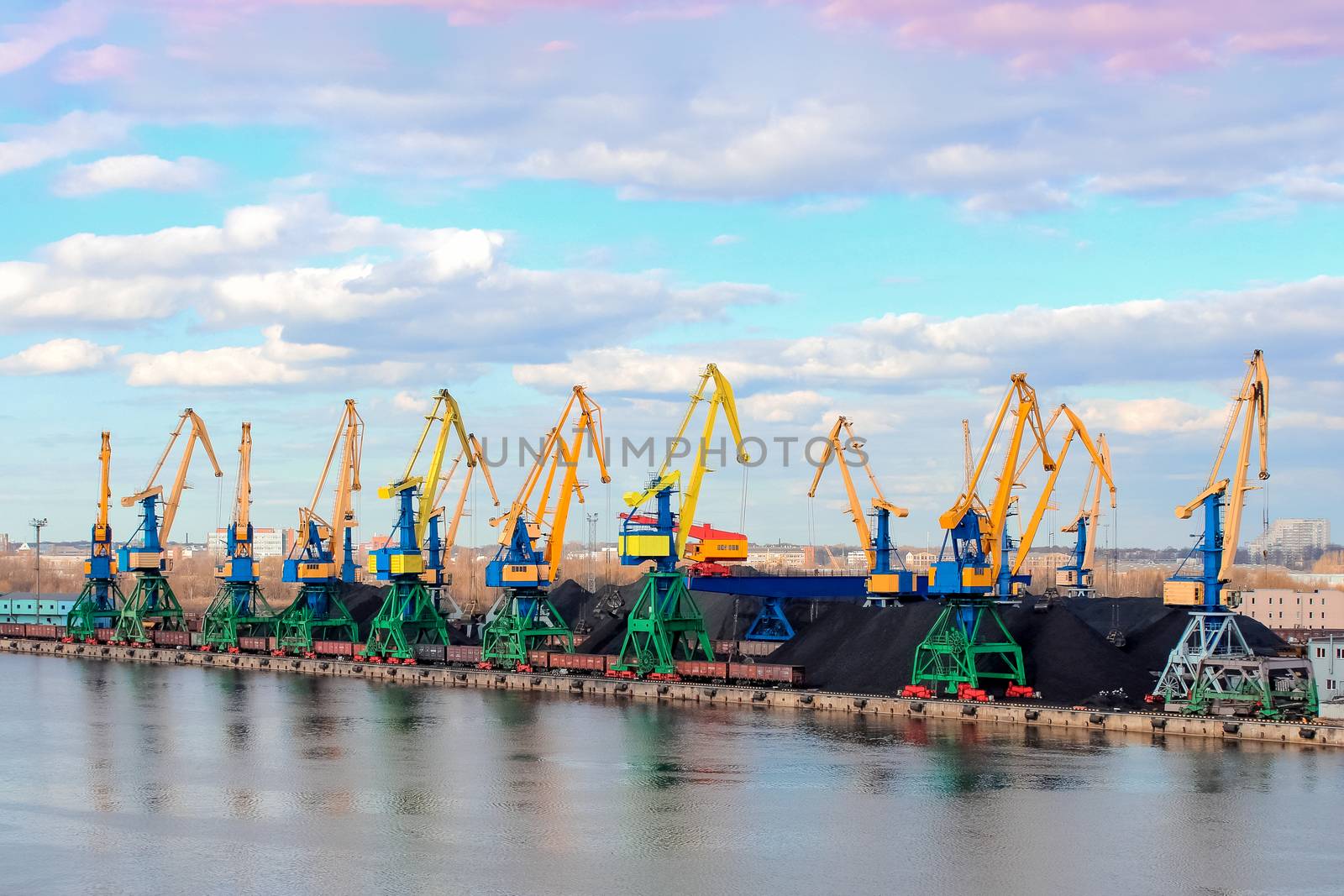 Baltic coal terminal with port cranes near the river. Riga cargo