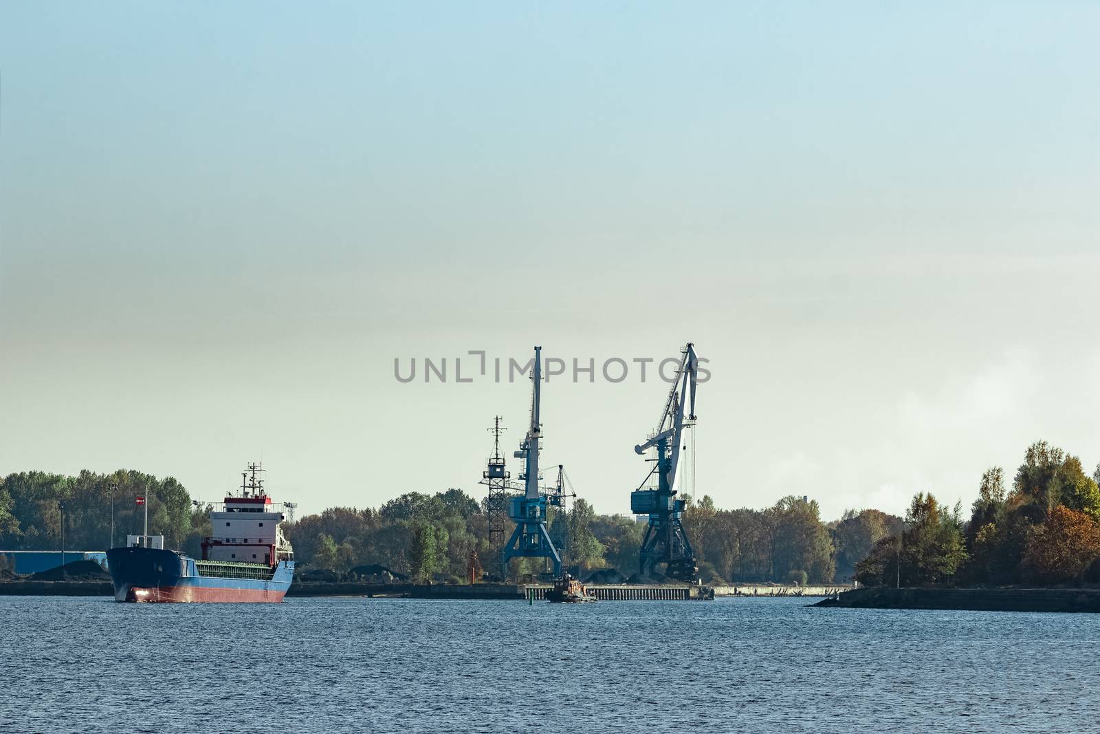 Blue cargo ship leaving the port of Riga