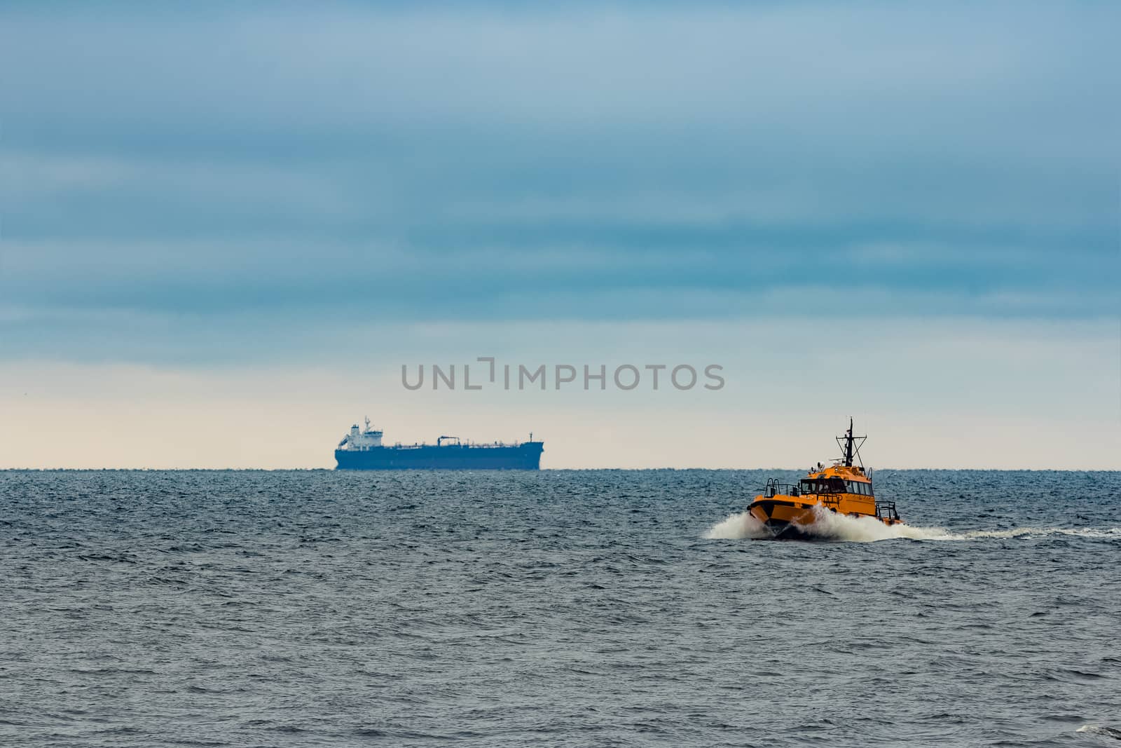 Orange pilot ship moving at speed in Baltic sea