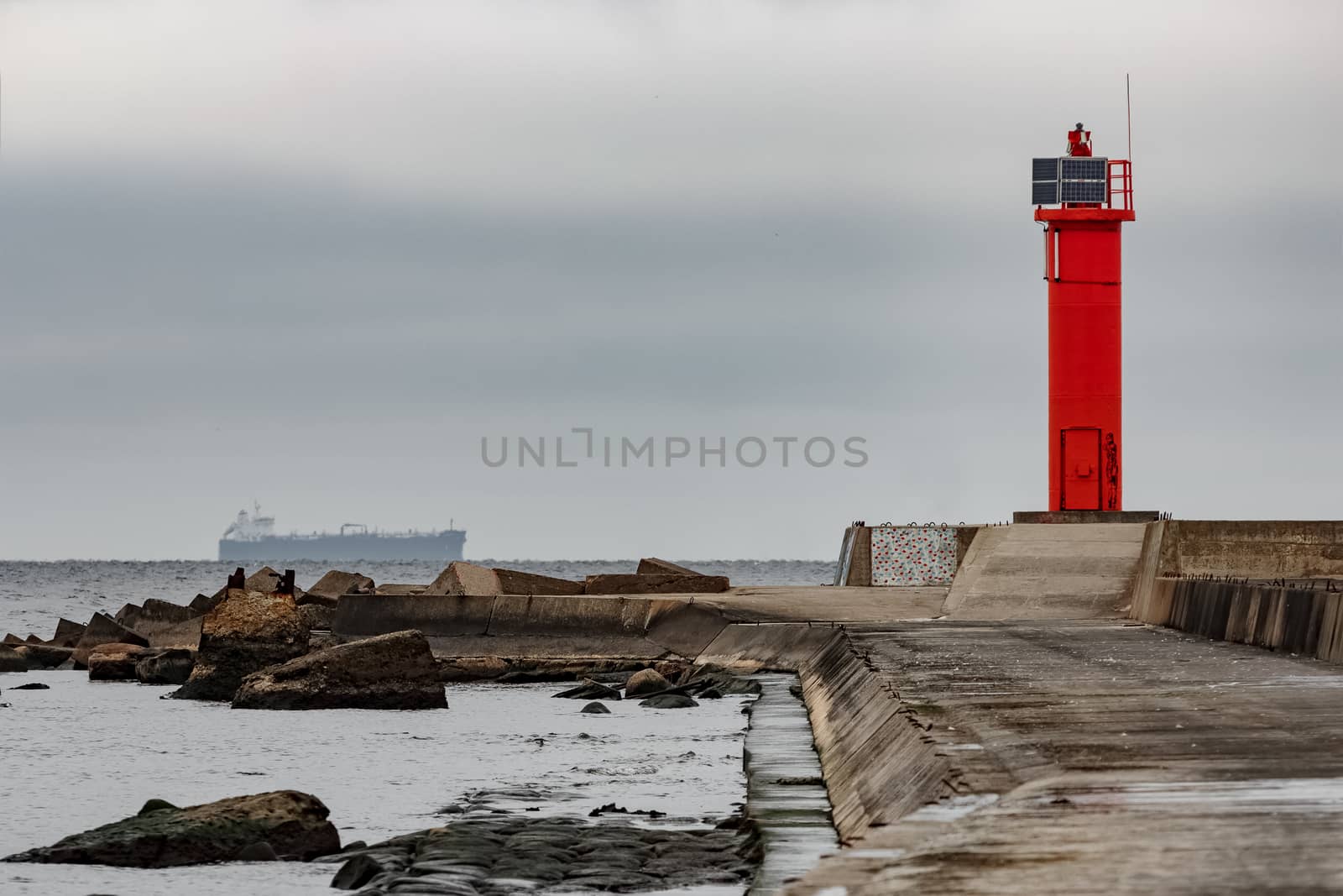 Breakwater dam with red lighthouse in Riga, Europe