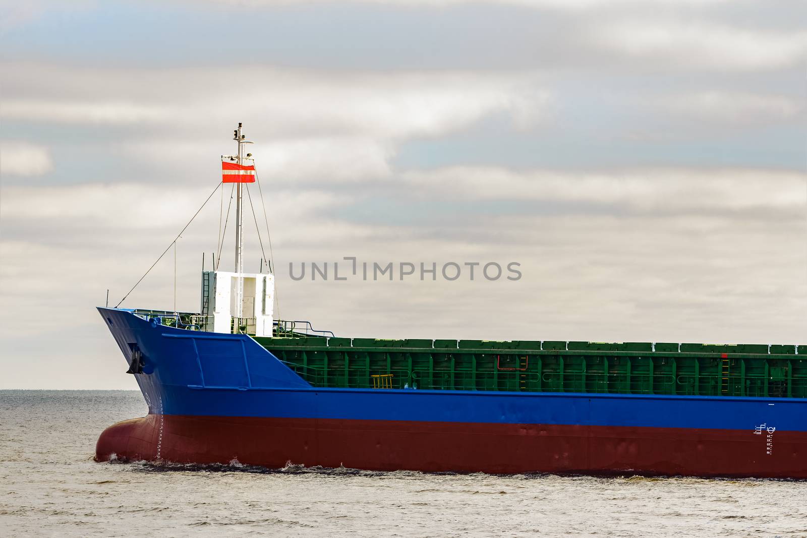 Blue cargo ship's bow leaving the port of Riga