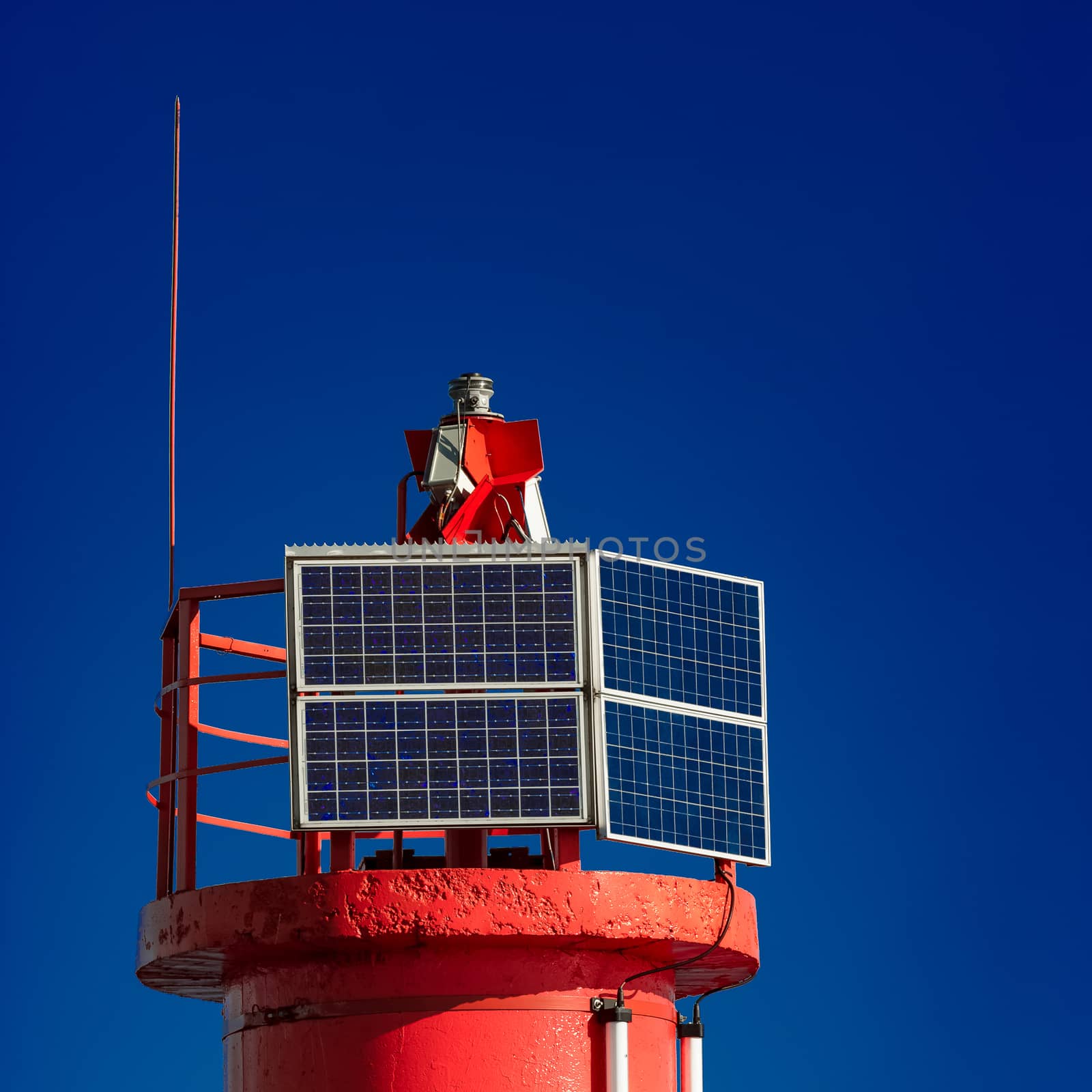 Red lighthouse against blue sky by sengnsp