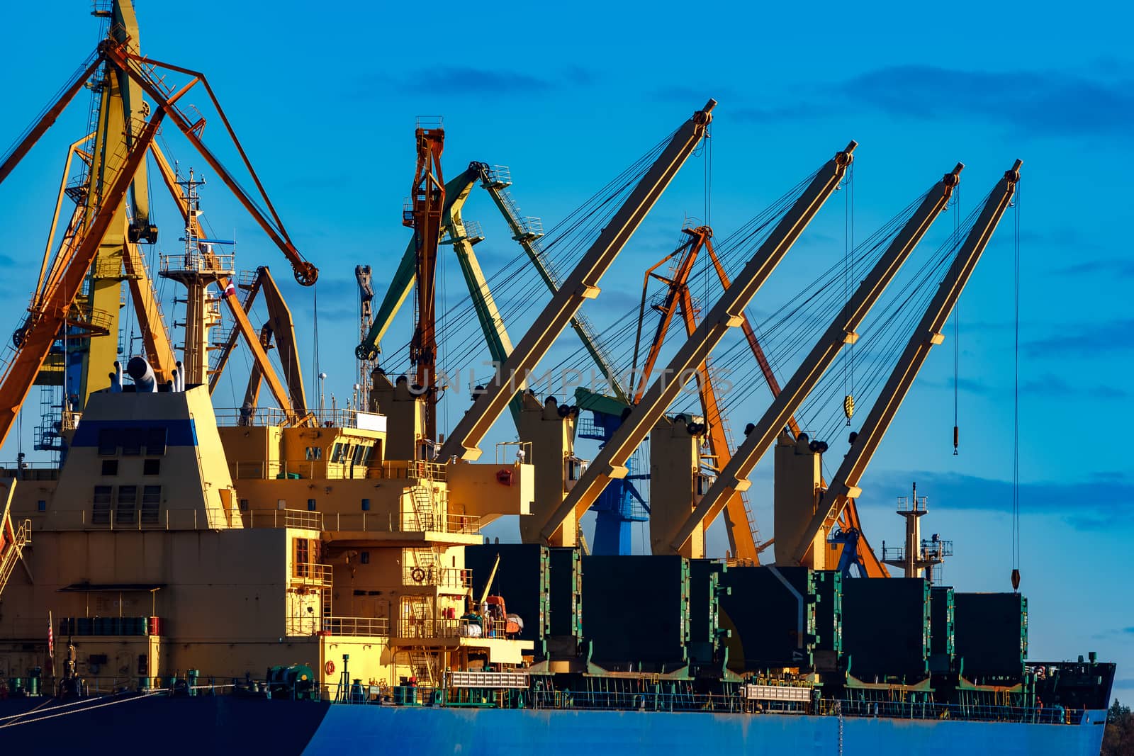 Blue cargo ship loading in the port of Riga, Europe