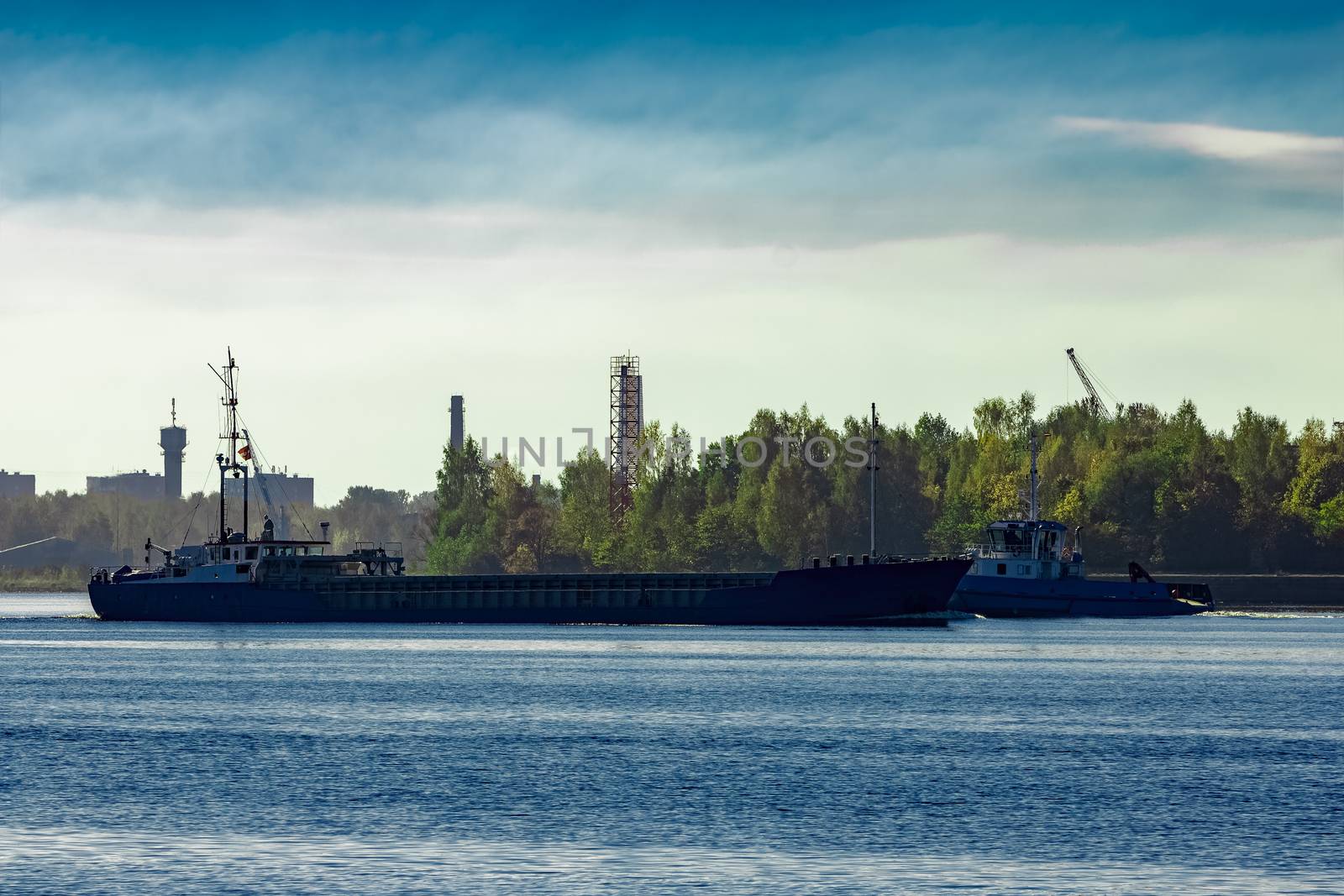 Blue cargo ship leaving Riga and entering Baltic sea