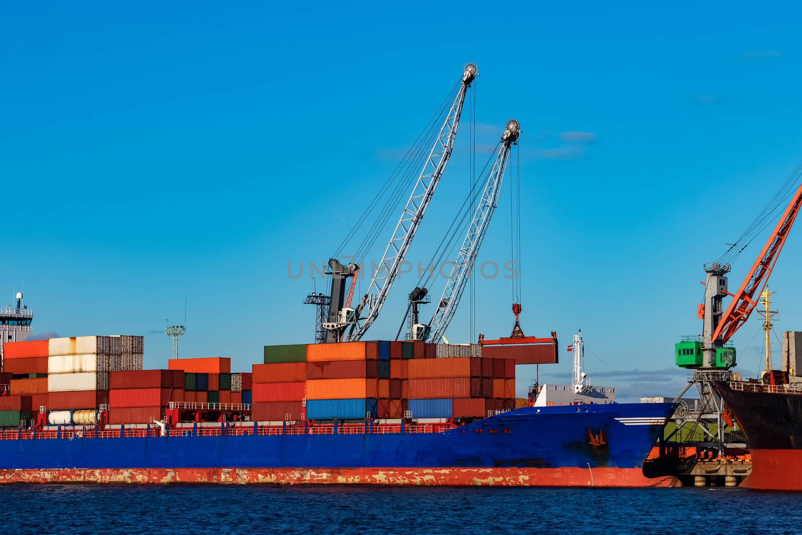 Blue container ship loading in cargo port of Europe