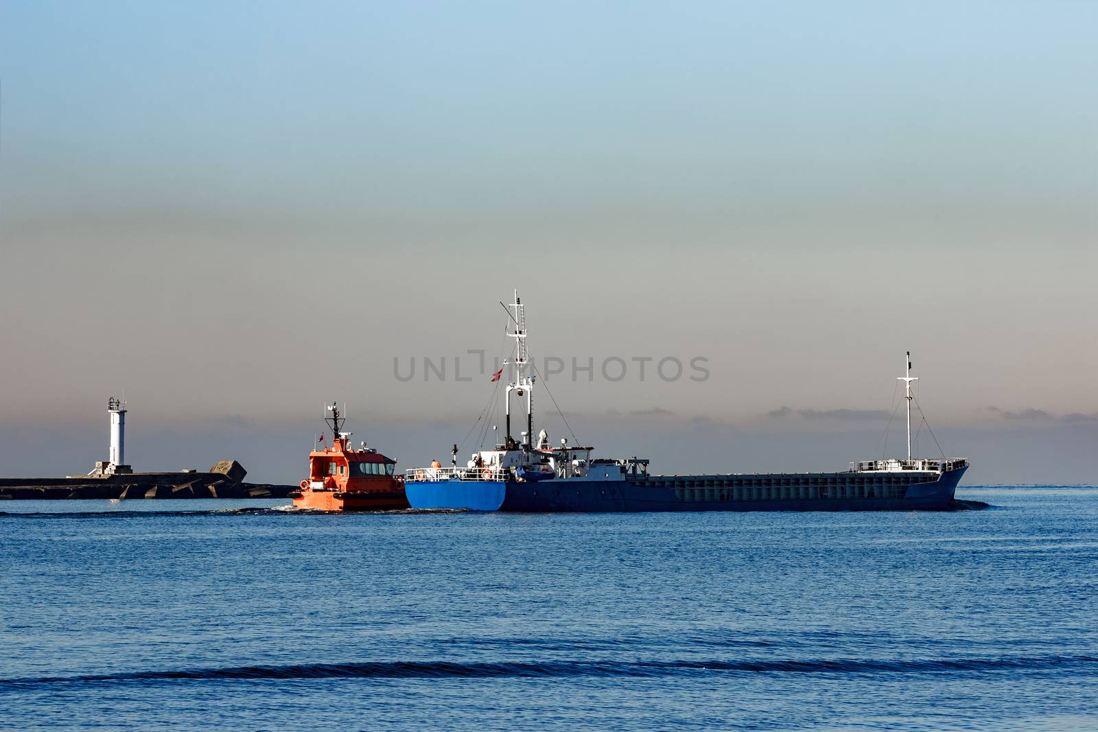 Blue cargo ship leaving Riga and entering Baltic sea