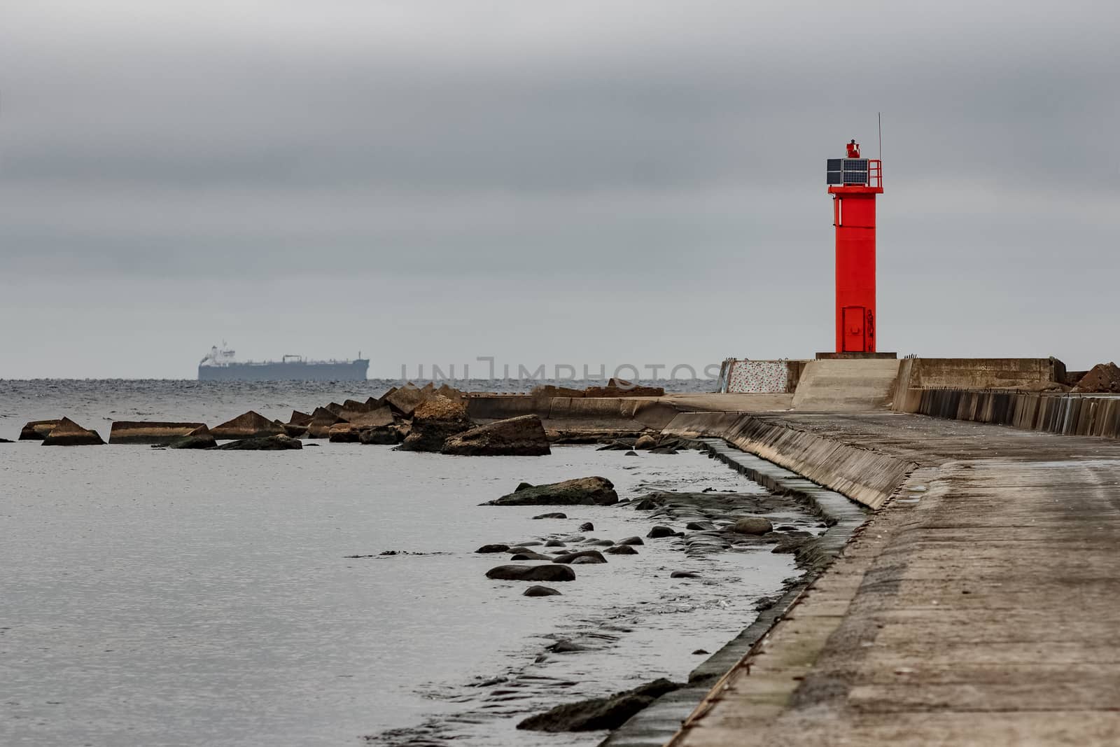 Breakwater dam with red lighthouse in Riga, Europe