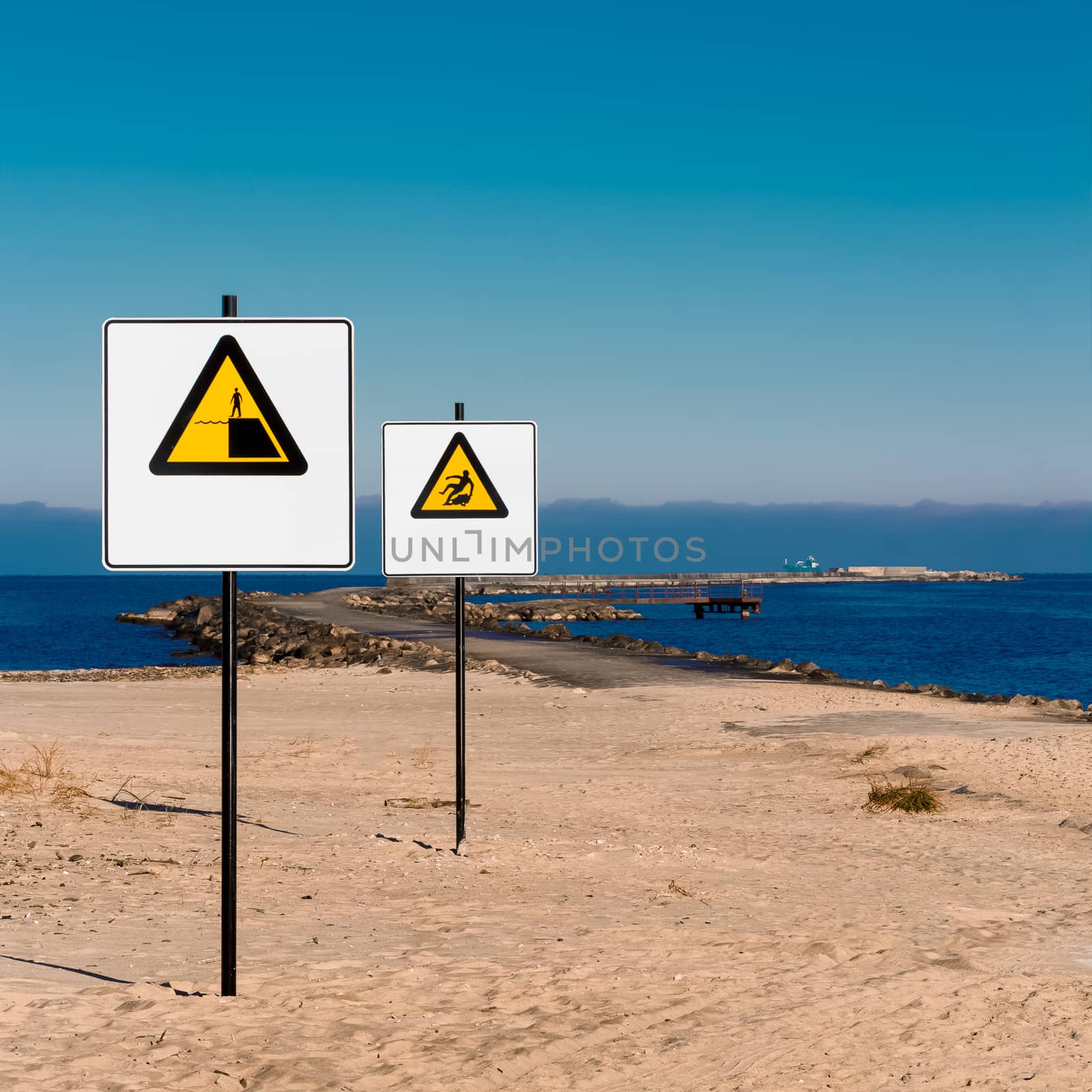 Yellow warning signs on summer beach, Riga