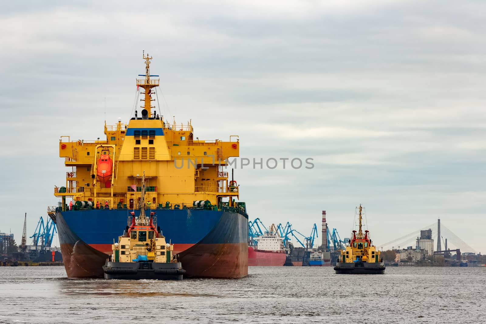 Blue cargo ship entering the port of Riga, Europe