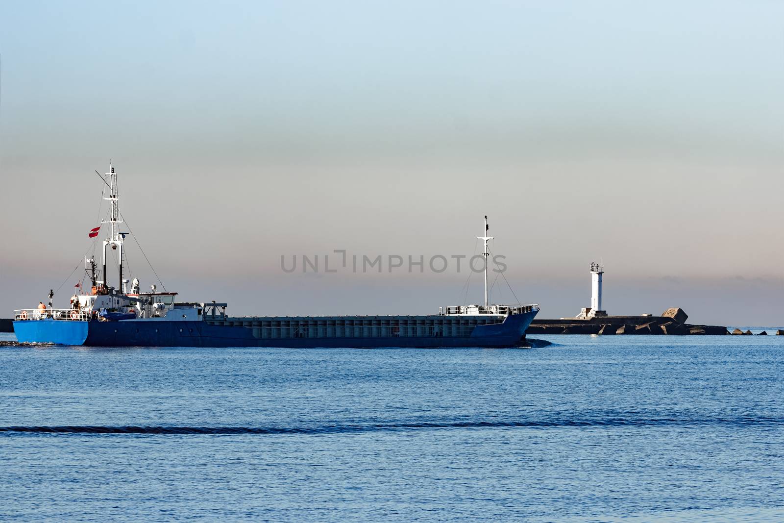 Blue cargo ship leaving Riga and entering Baltic sea