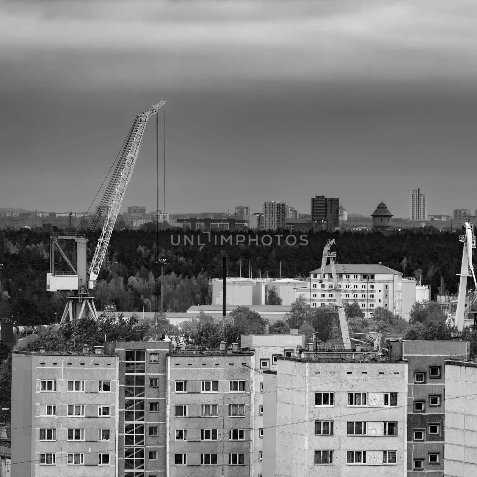 Residential area in Riga with soviet houses and cargo cranes