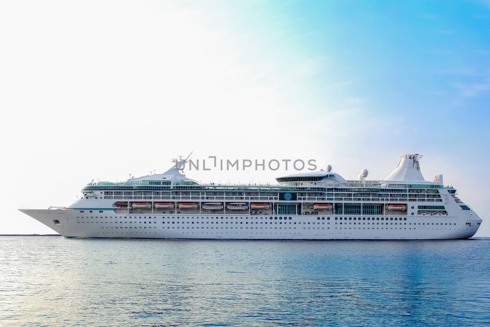 White cruise ship underway. Passenger ship leaving port of Riga