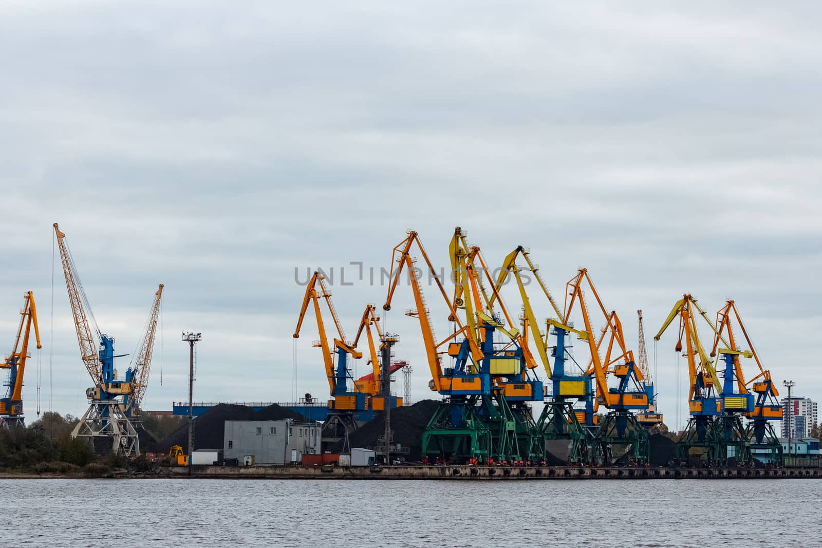 Yellow cargo cranes in the port of Riga, Europe